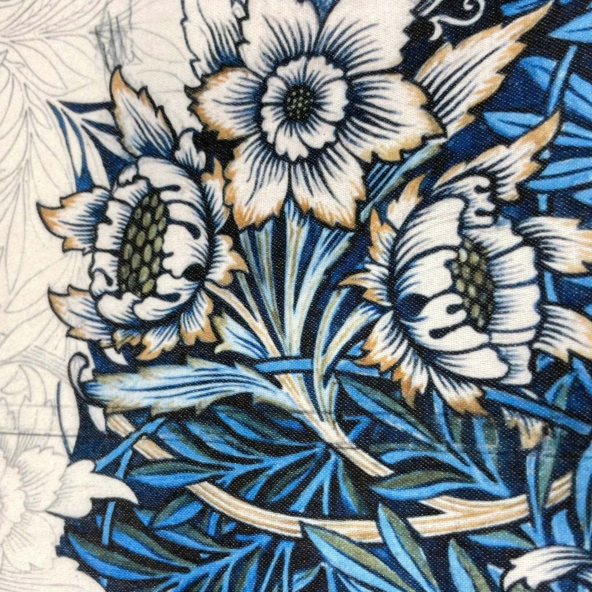 Close-up of intertwined blue willow leaves and white blossoms — design detail from William Morris's 1873 Tulip and Willow pattern.