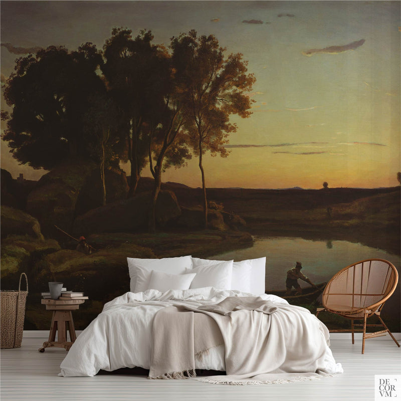 Corot twilight lake wallpaper mural in a bedroom with white bedding and rattan chair — serene landscape with silhouetted trees, still water, and golden sunset sky