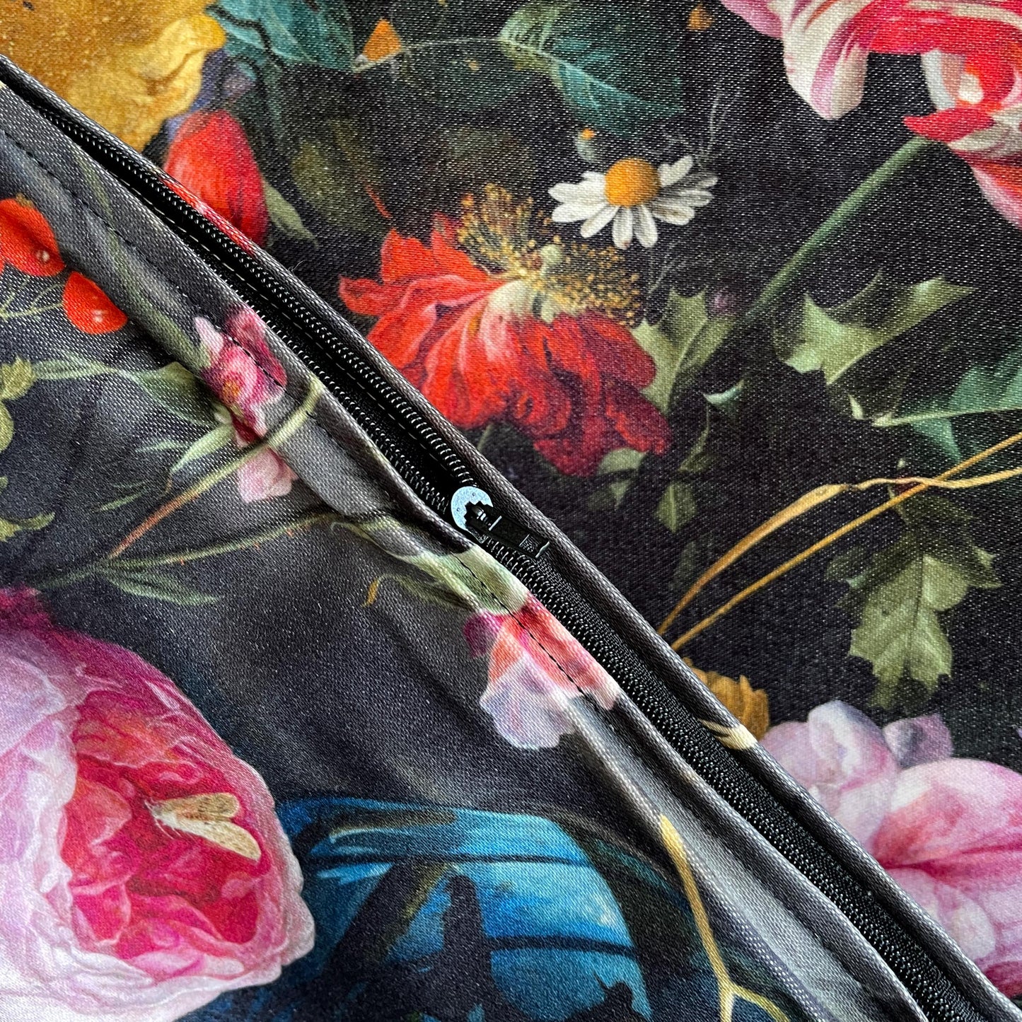 Close-up of the seamless black zipper closure and durable woven fabric on the Dutch Floral cushion cover.