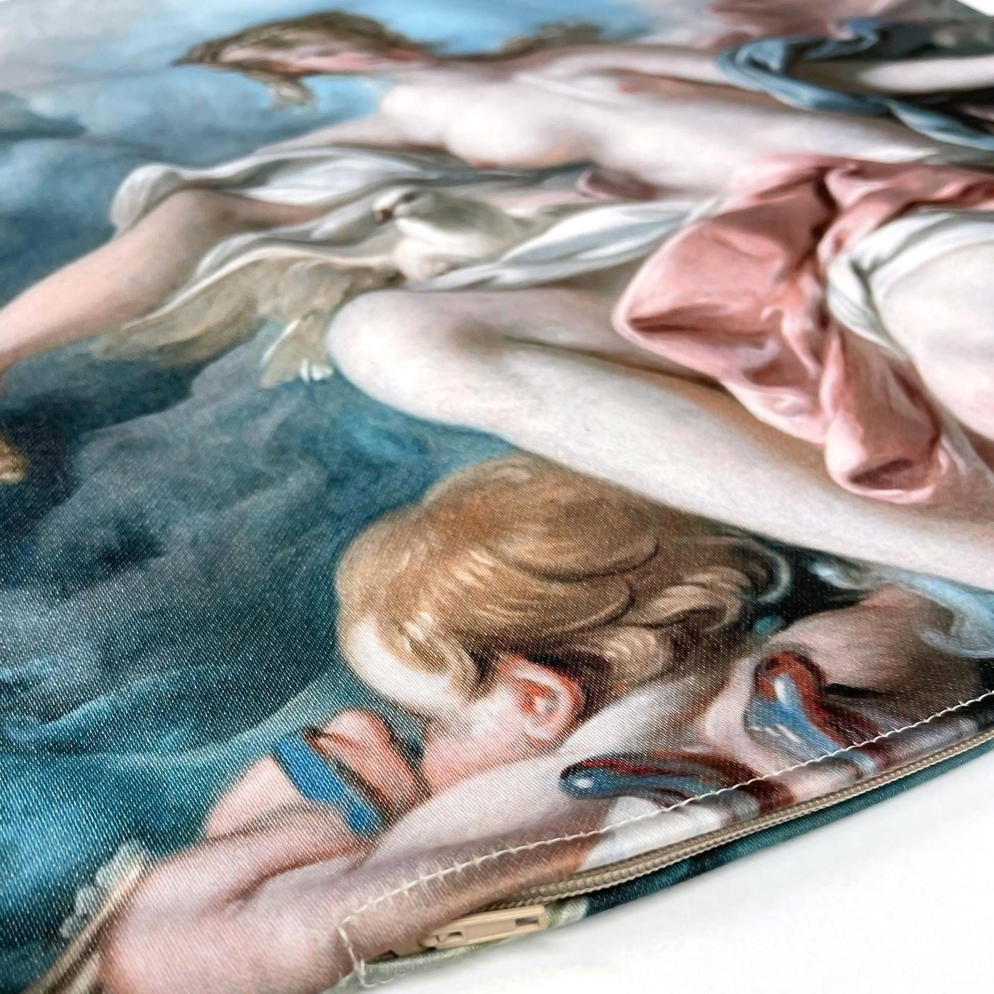 Angled macro of the French Rococo Venus pillow cover showing the cotton-polyester weave and a cherub figure at the edge.
