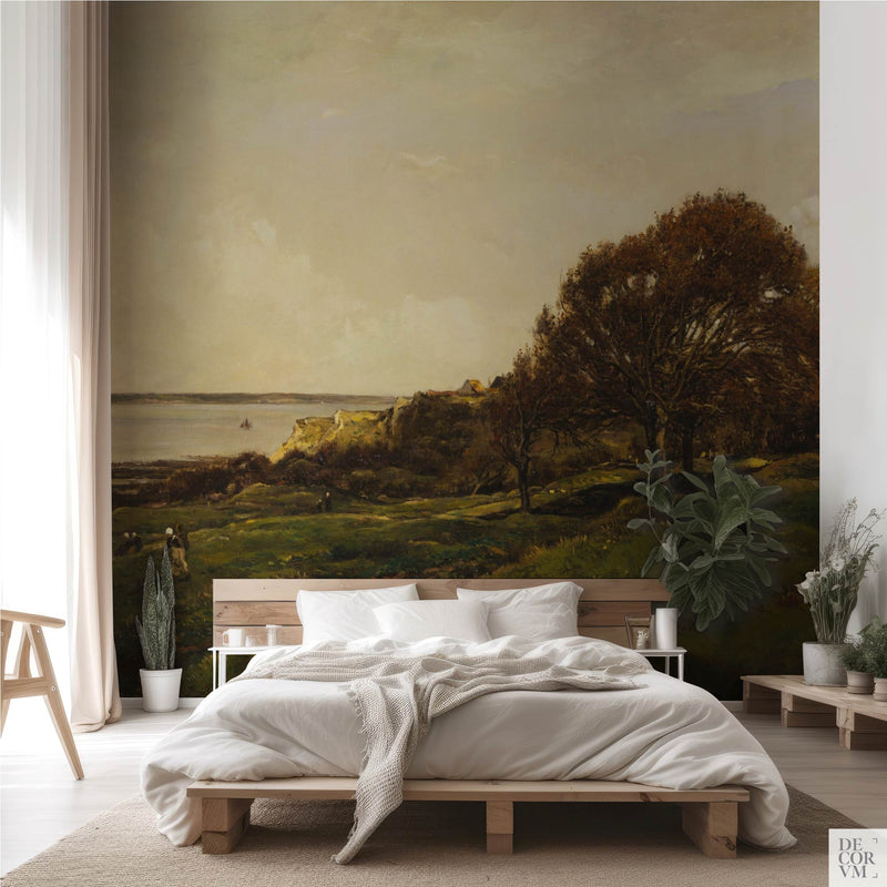 French seaside landscape wallpaper mural in a bohemian bedroom with wooden platform bed — vintage coastal landscape covering the full wall