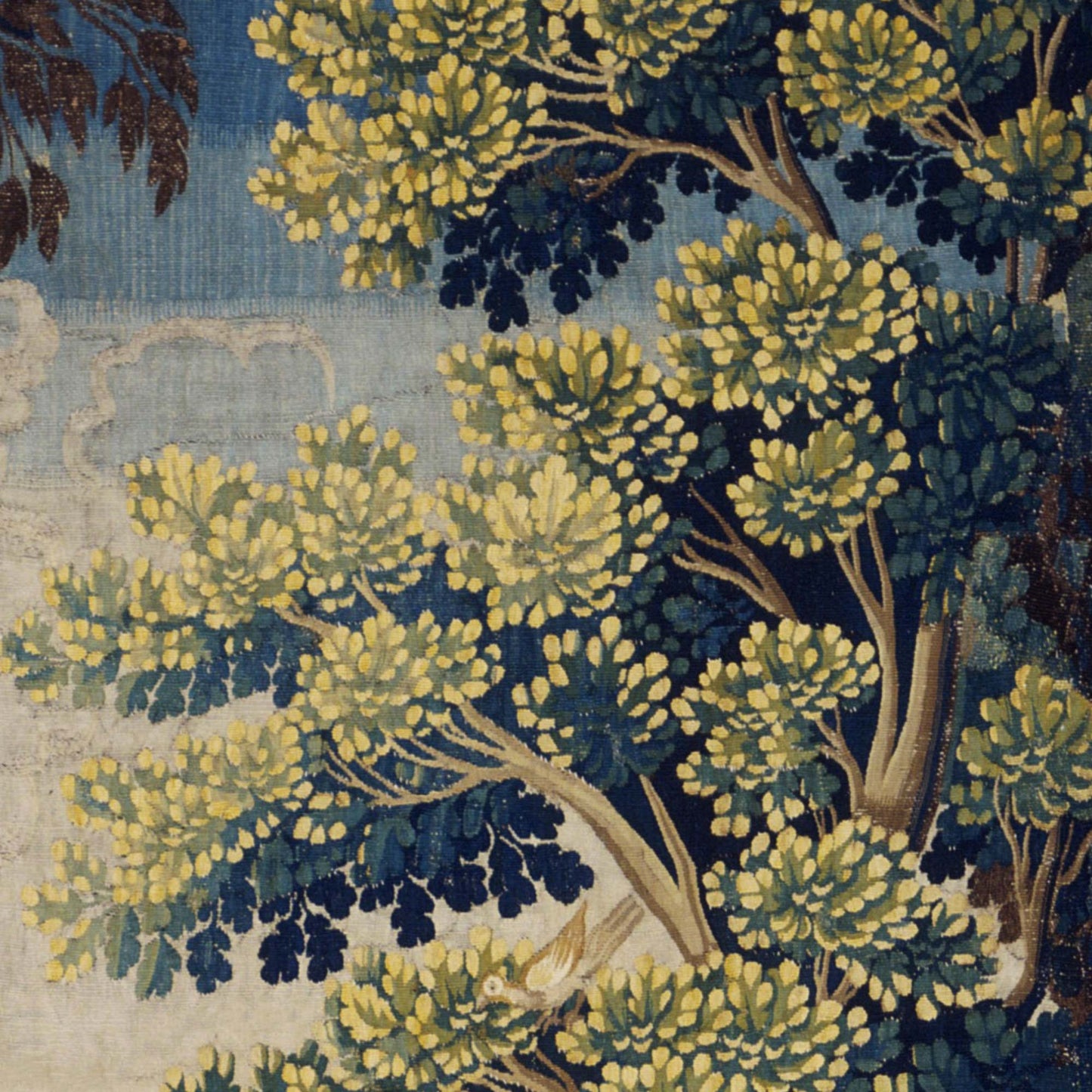 Layered tree canopies in yellow-green and deep blue with a small bird nestled in the foliage — design detail from the French verdure forest.