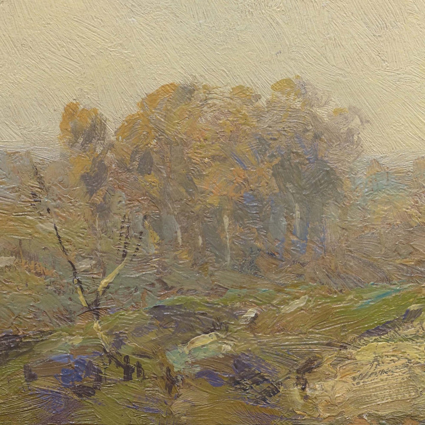 Detail of autumn landscape — distant cluster of golden trees in misty haze with green rolling hillside and blue-purple shadows