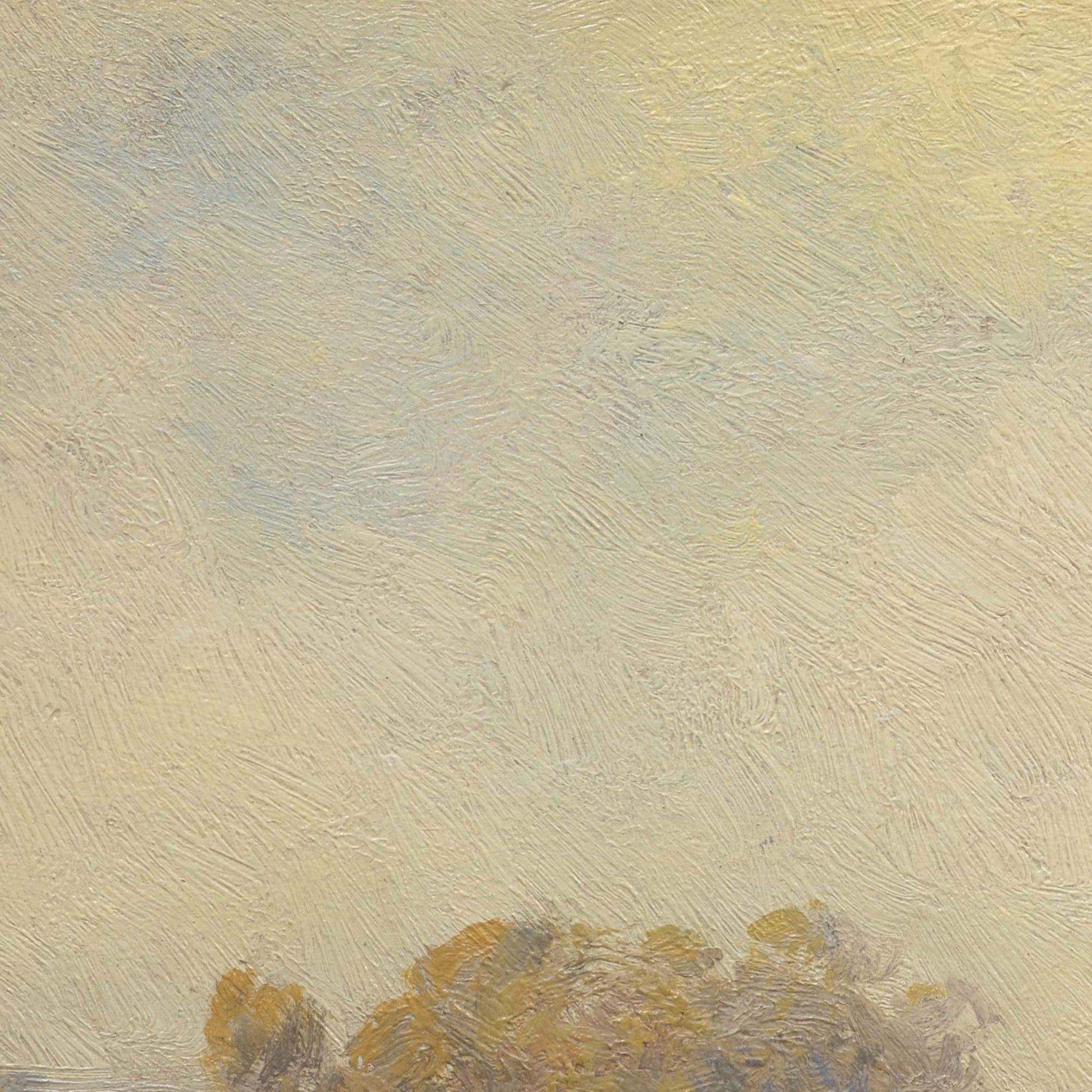 Detail of autumn sky — expansive pale golden sky with soft blue-grey clouds and tiny golden treetops at bottom edge