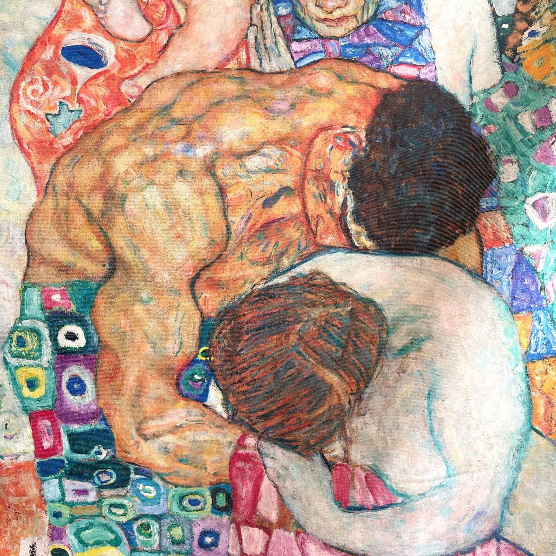 Close-up of the central embrace of the nude figures and surrounding patchwork patterns — design detail from Gustav Klimt's Death and Life painting.