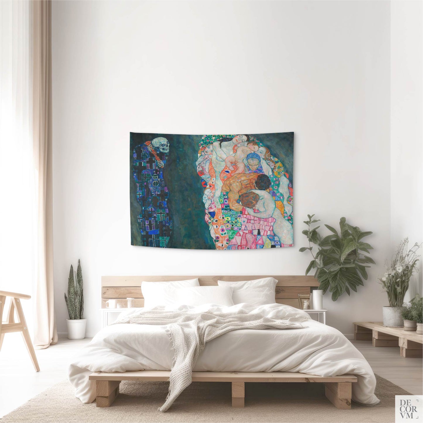 Small Gustav Klimt Death and Life wall tapestry mounted above a natural wood bed in a bright modern bedroom — art nouveau allegorical decor.