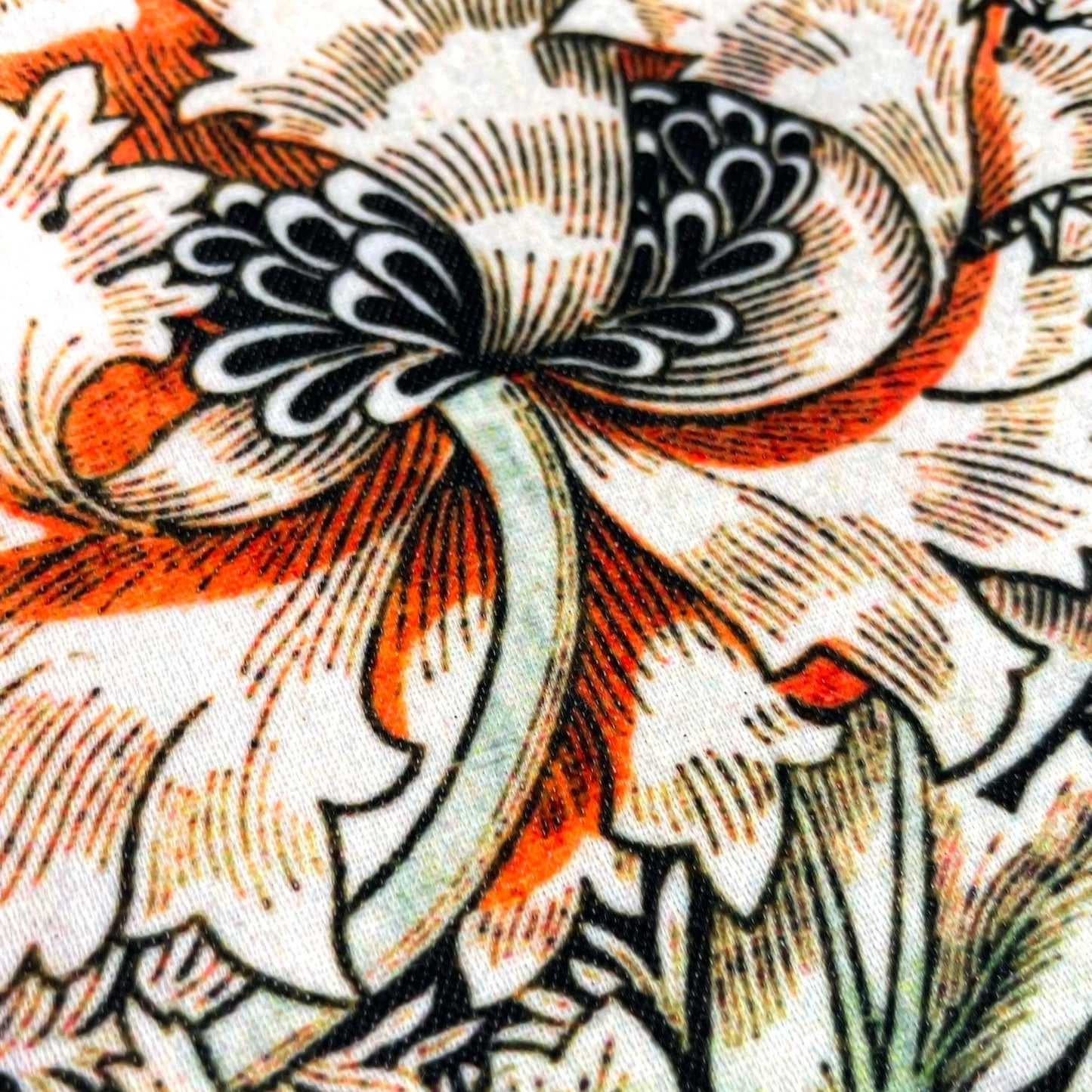 Extreme close-up of an orange honeysuckle blossom — design detail from May Morris's 1883 Honeysuckle pattern.