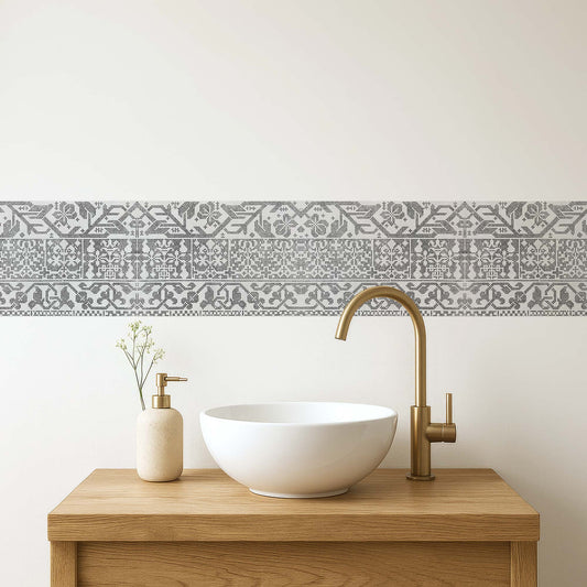 Italian lacework peel and stick wall border in light gray — transitional bathroom vanity with modern white vessel sink and brass fixtures by Decorvm