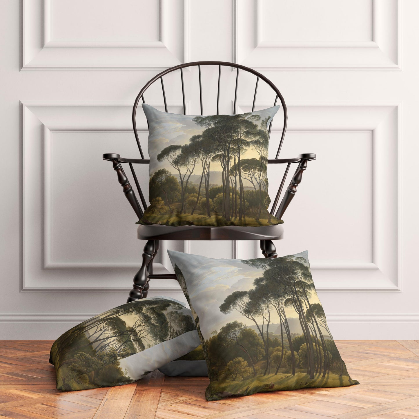Three vintage Italian landscape throw pillows elegantly styled on and around a traditional dark wooden chair in a bright, transitional living room with white paneled walls.