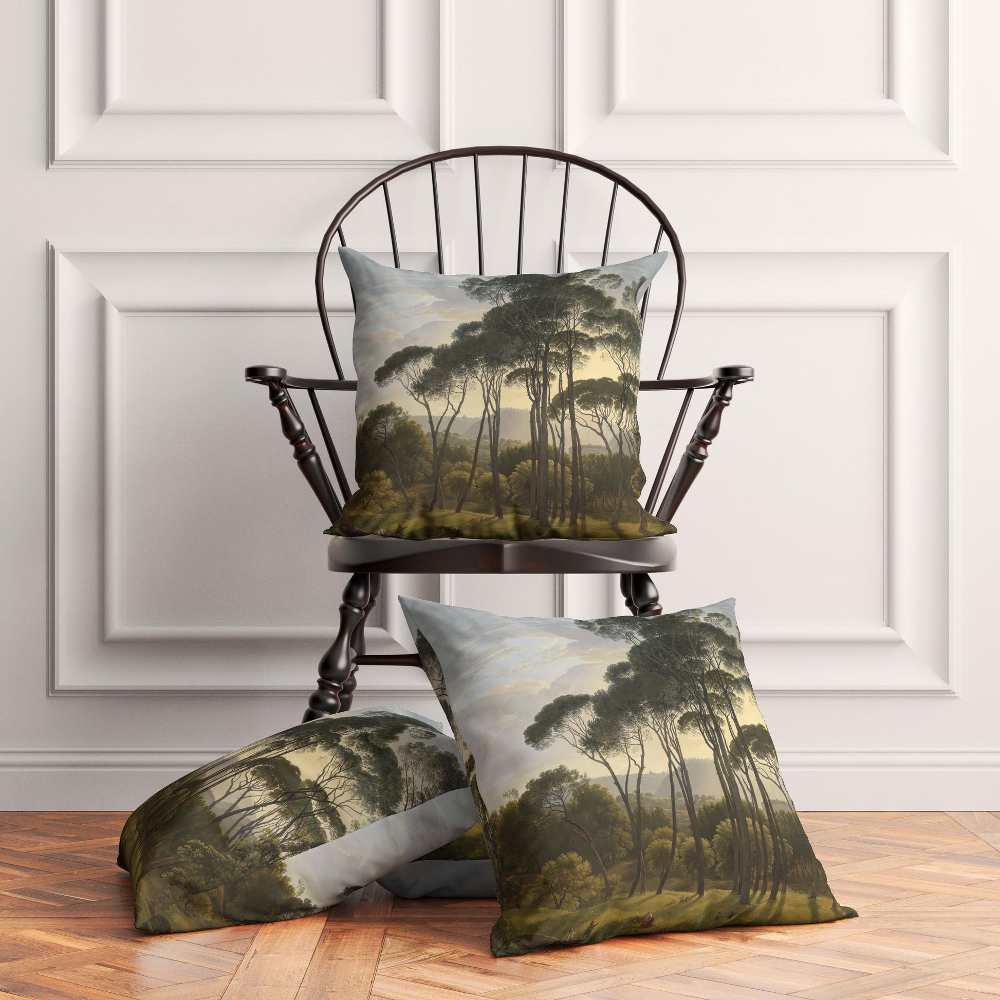 Three vintage Italian landscape throw pillows elegantly styled on and around a traditional dark wooden chair in a bright, transitional living room with white paneled walls.