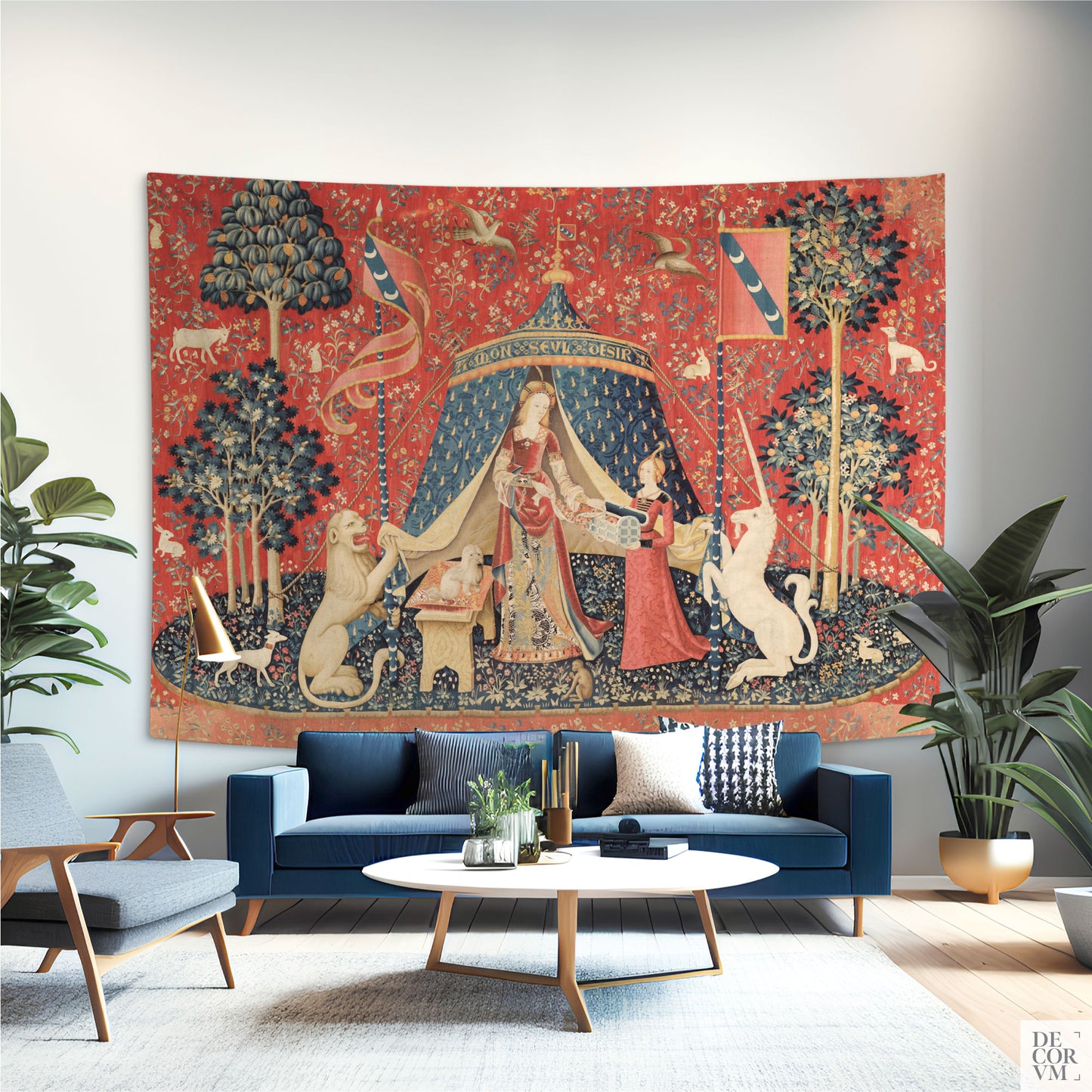 Wide Lady and the Unicorn medieval tapestry as a statement piece behind a blue velvet sofa in a modern living room.