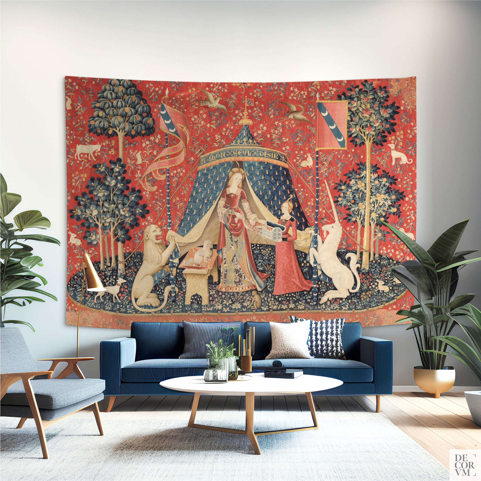 Wide Lady and the Unicorn medieval tapestry as a statement piece behind a blue velvet sofa in a modern living room.