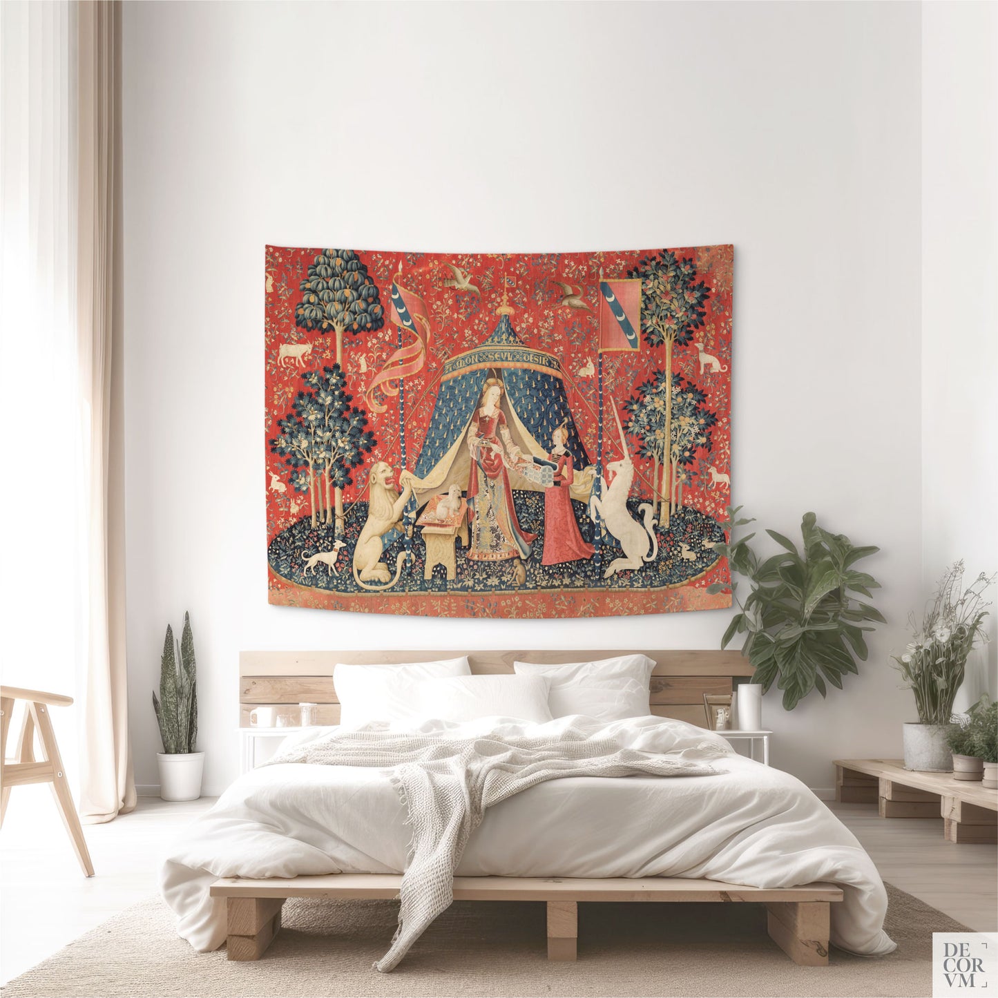 Medium Lady and the Unicorn medieval millefleur tapestry as a historical accent in a modern bedroom with a low wooden bed and textured white bedding.