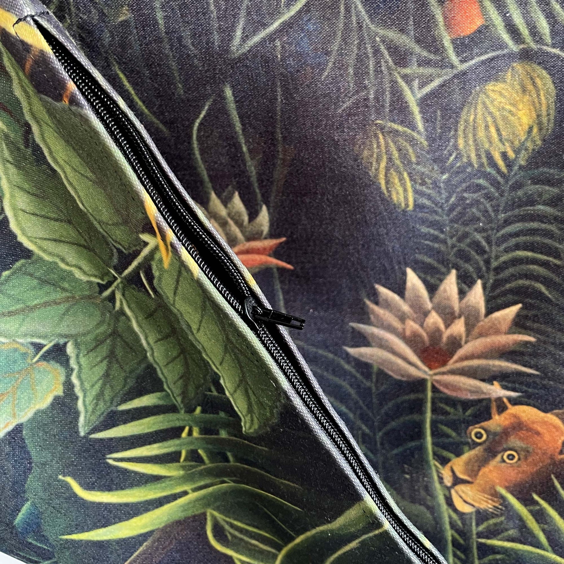 Hidden zipper and emerald foliage detail — painting detail from Henri Rousseau's 1910 The Dream featuring lotus and a stylised lion.