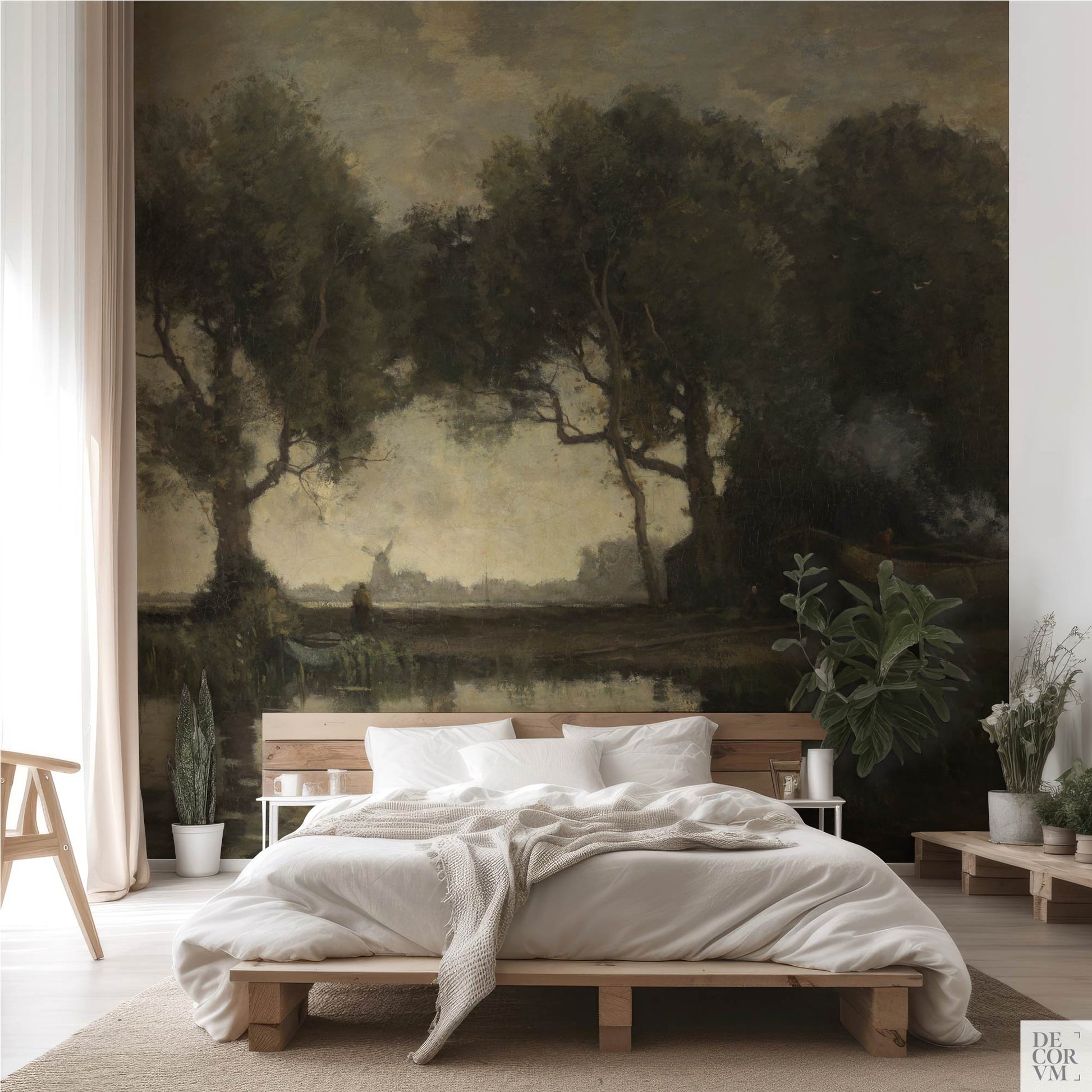 Moody countryside landscape wallpaper mural behind a natural wood platform bed with white bedding, sheer curtains, and potted plants — earthy boho bedroom accent wall
