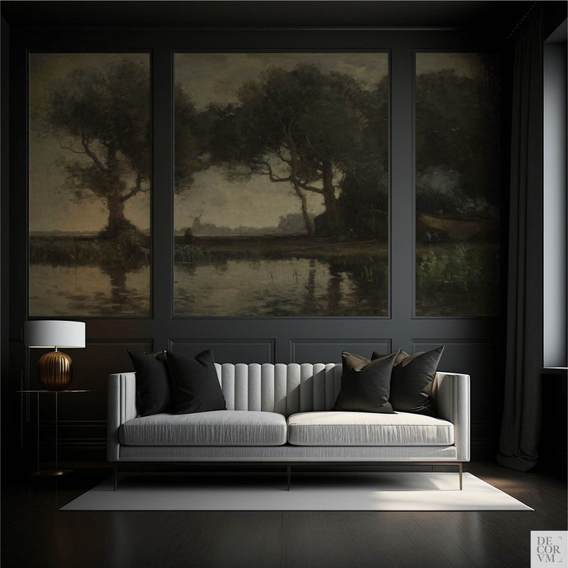 Moody vintage landscape wallpaper mural in a dark paneled living room with charcoal walls, grey channel-tufted sofa, black velvet pillows, and brass lamp — dark academia triptych wall decor