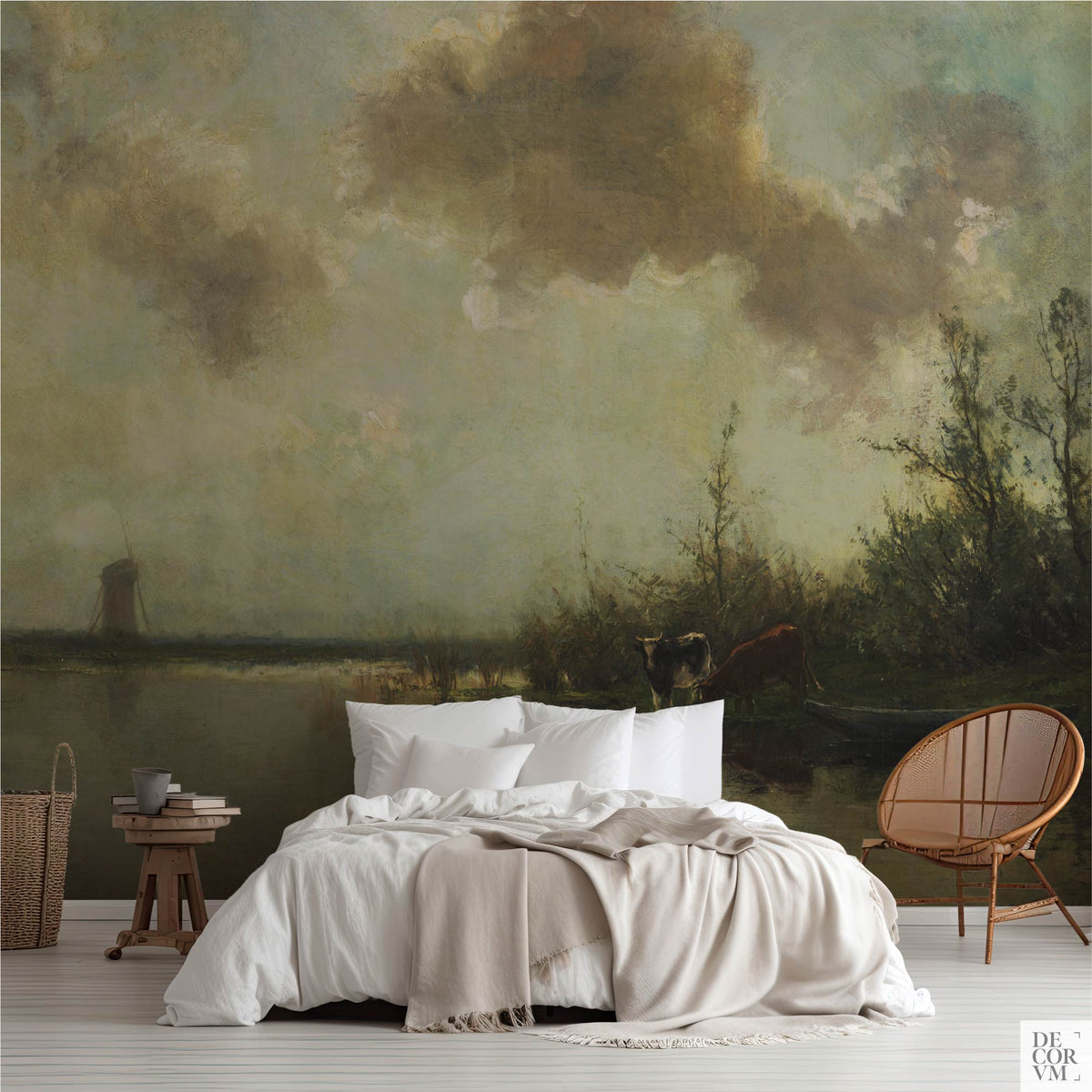 Pastoral cows on a riverbank wallpaper mural in a bedroom with white bedding, rattan chair, and wooden stool