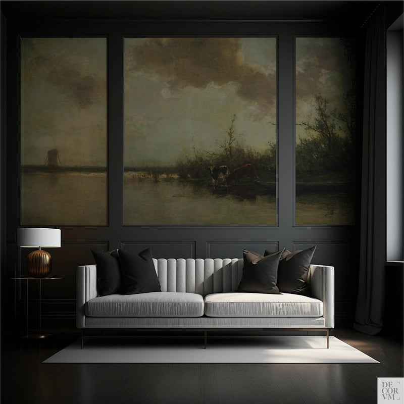 Pastoral cows on a riverbank wallpaper mural in three dark-framed panels in an elegant living room with gray sofa