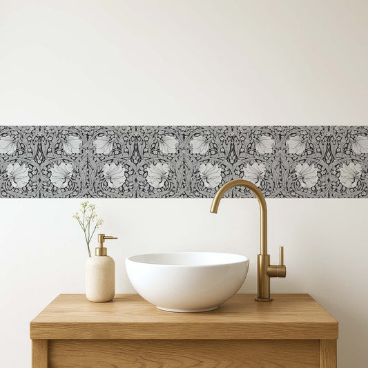 William Morris Pimpernel peel and stick wall border in grayscale — modern bathroom vanity with white vessel sink and gold faucet by Decorvm