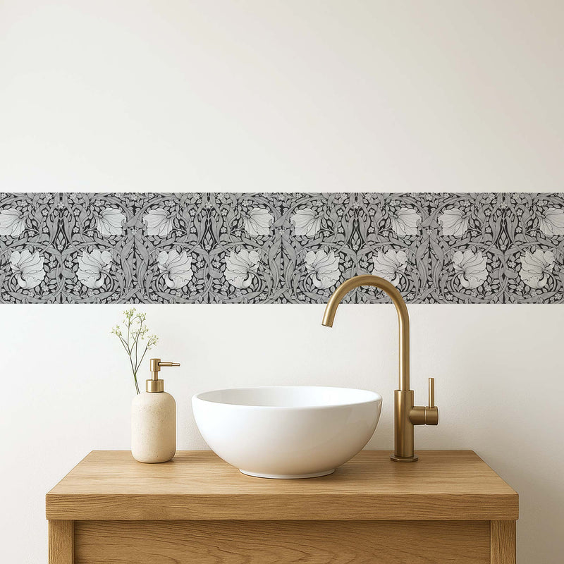 William Morris Pimpernel peel and stick wall border in grayscale — modern bathroom vanity with white vessel sink and gold faucet by Decorvm
