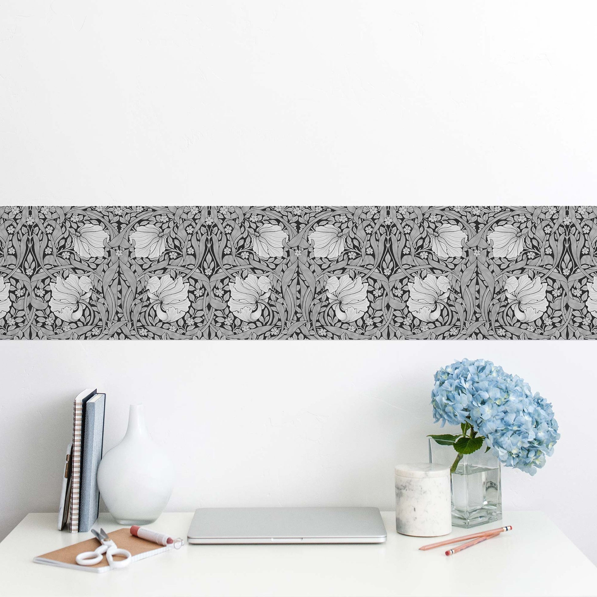 William Morris Pimpernel peel and stick wall border in grayscale — minimalist home office workspace with horizontal monochrome floral strip