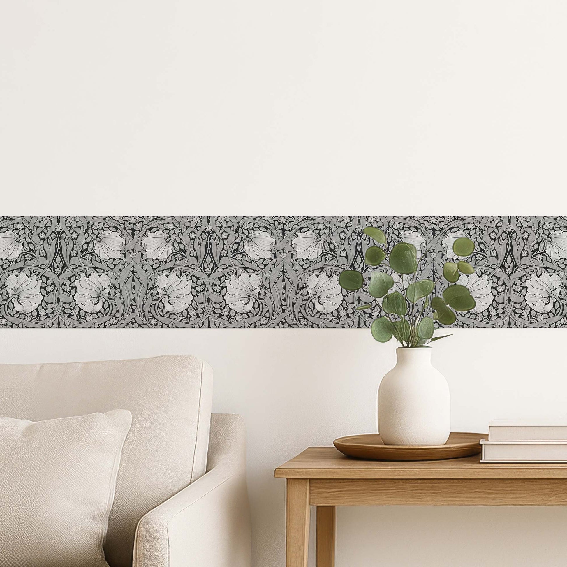 William Morris Pimpernel peel and stick wall border in grayscale — cozy living room with beige sofa and historic monochrome floral wall border