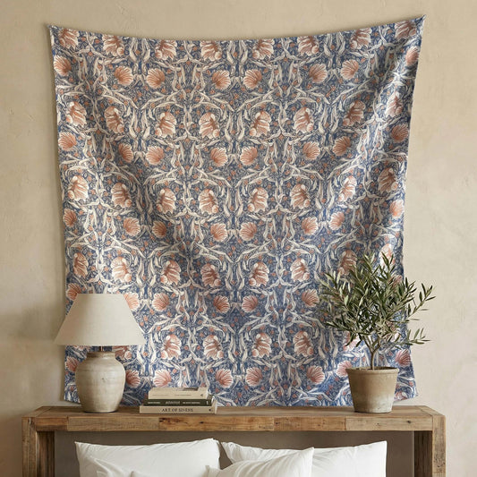 William Morris Pimpernel wall tapestry above a wooden console — 1876 Arts and Crafts woven jacquard in navy, rust, and ivory by Decorvm.