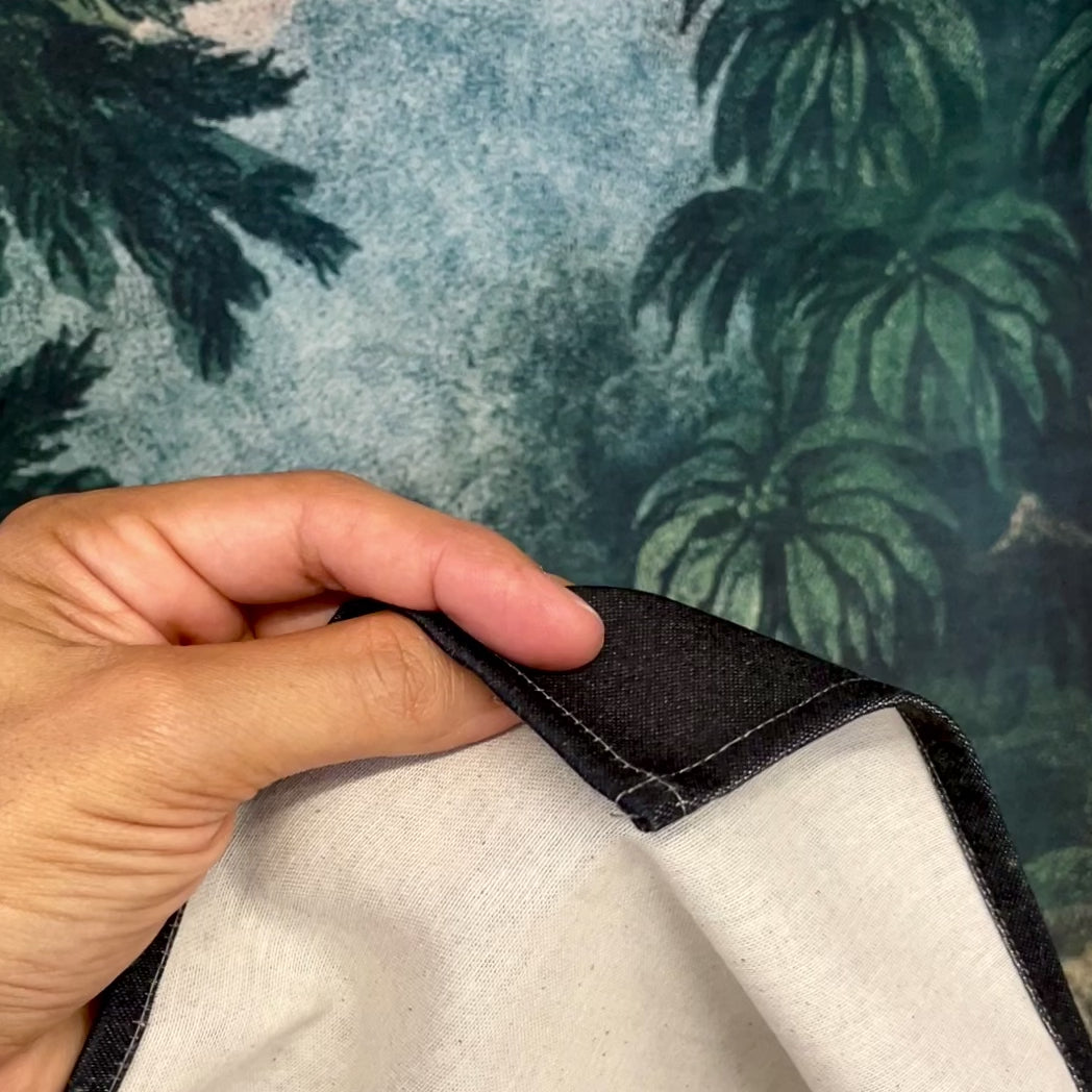Video demonstrating the fabric quality and printed design of the vintage exotic jungle wall tapestry, showing a close-up of the hem and panning across the tropical landscape.