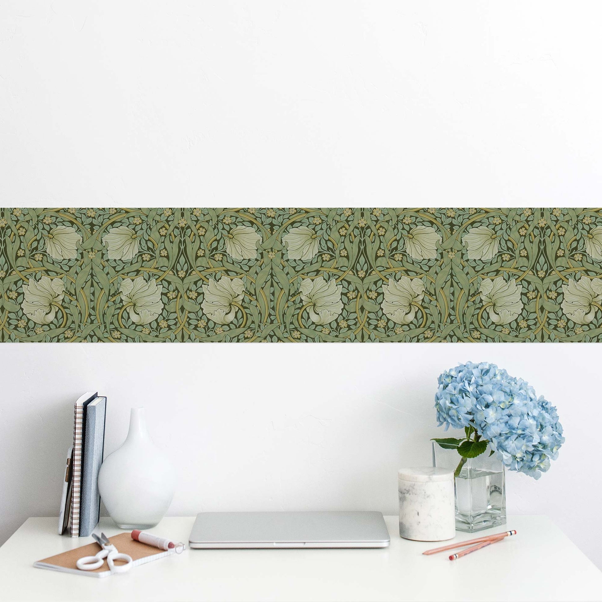 William Morris Pimpernel peel and stick wall border in sage — framing a home office desk with laptop and blue hydrangeas in cottage style