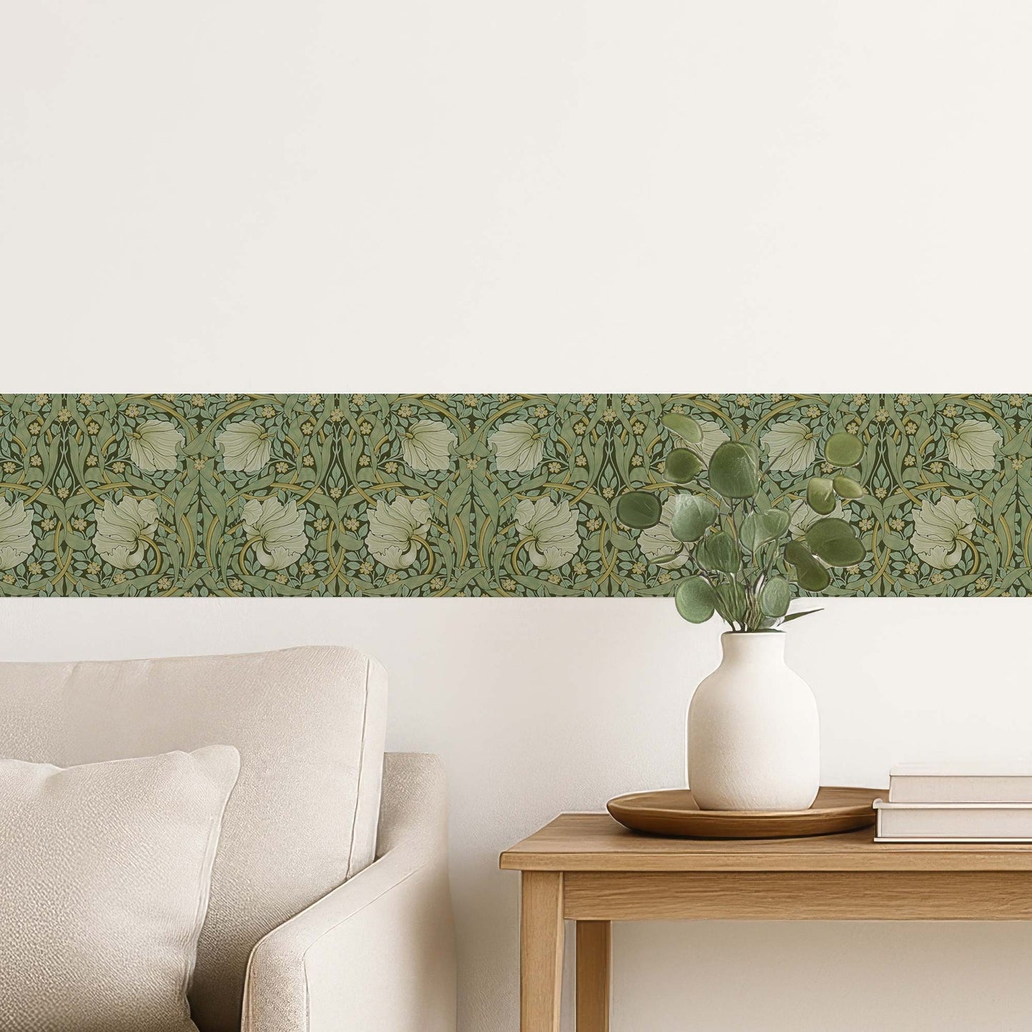 William Morris Pimpernel peel and stick wall border in sage — close-up styling in a living room with white vase showing swirling green foliage
