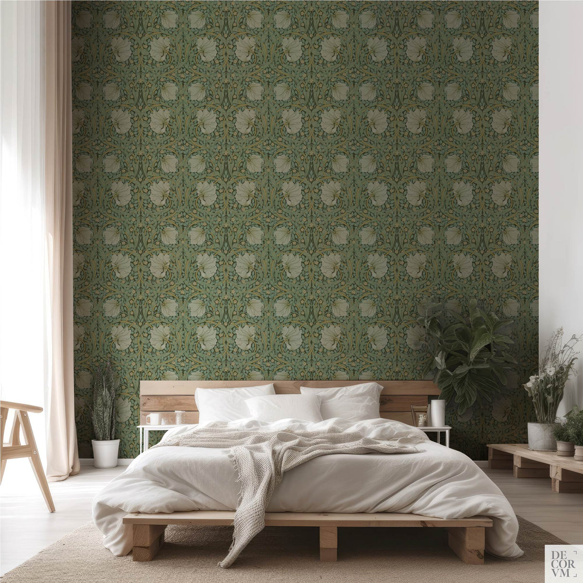 Minimalist bedroom interior showcasing the William Morris Pimpernel Wallpaper Mural — Sage Arts & Crafts Decor behind a low wooden bed frame, sheer curtains, and potted plants.