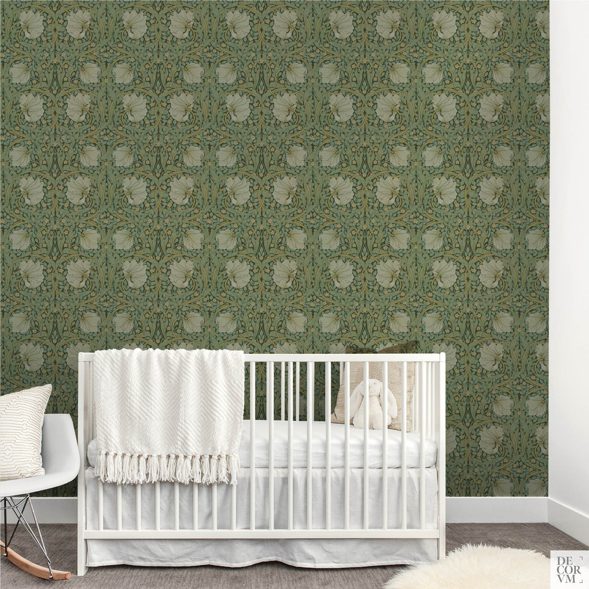 Nursery room setup with a white crib placed directly in front of the William Morris Pimpernel Wallpaper Mural — Sage Arts & Crafts Decor, with a white rocking chair to the left.