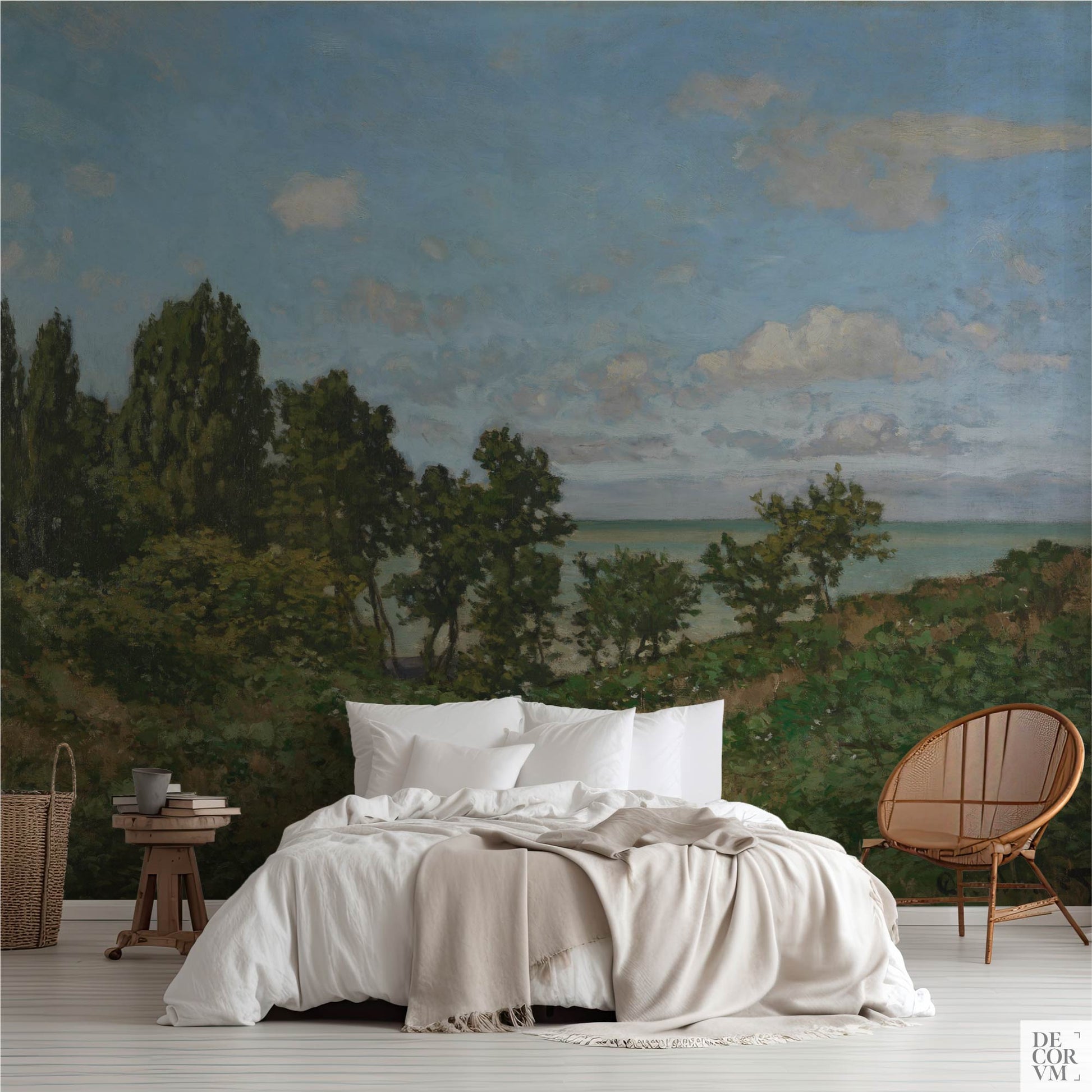 Monet coastal landscape wallpaper mural in a bright bedroom — impressionist Normandy cliffs and sky behind a white bed with rattan chair