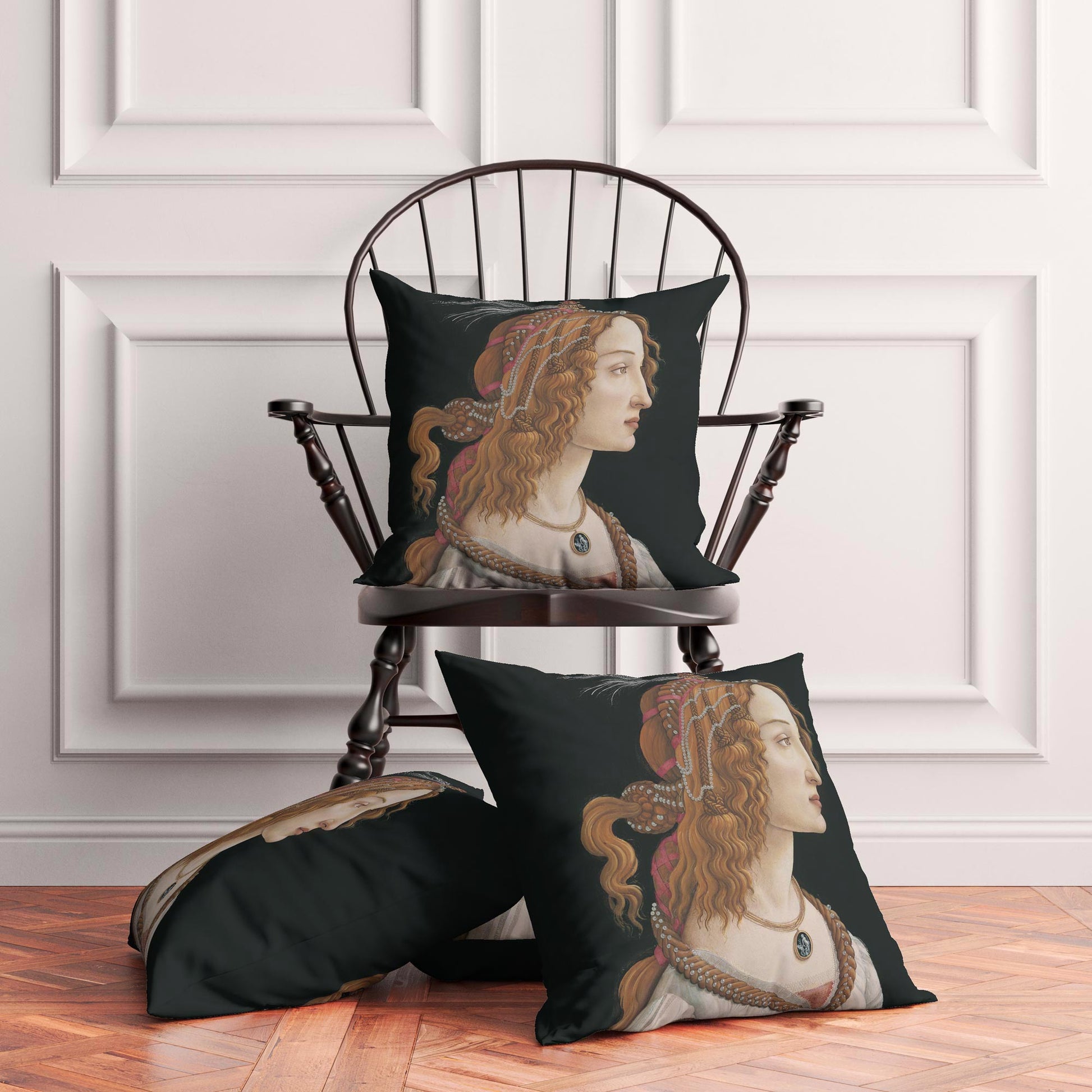 Three Botticelli Simonetta Vespucci cushion covers staged in a dark academia bedroom, one on a wooden Windsor chair and two on parquet flooring.