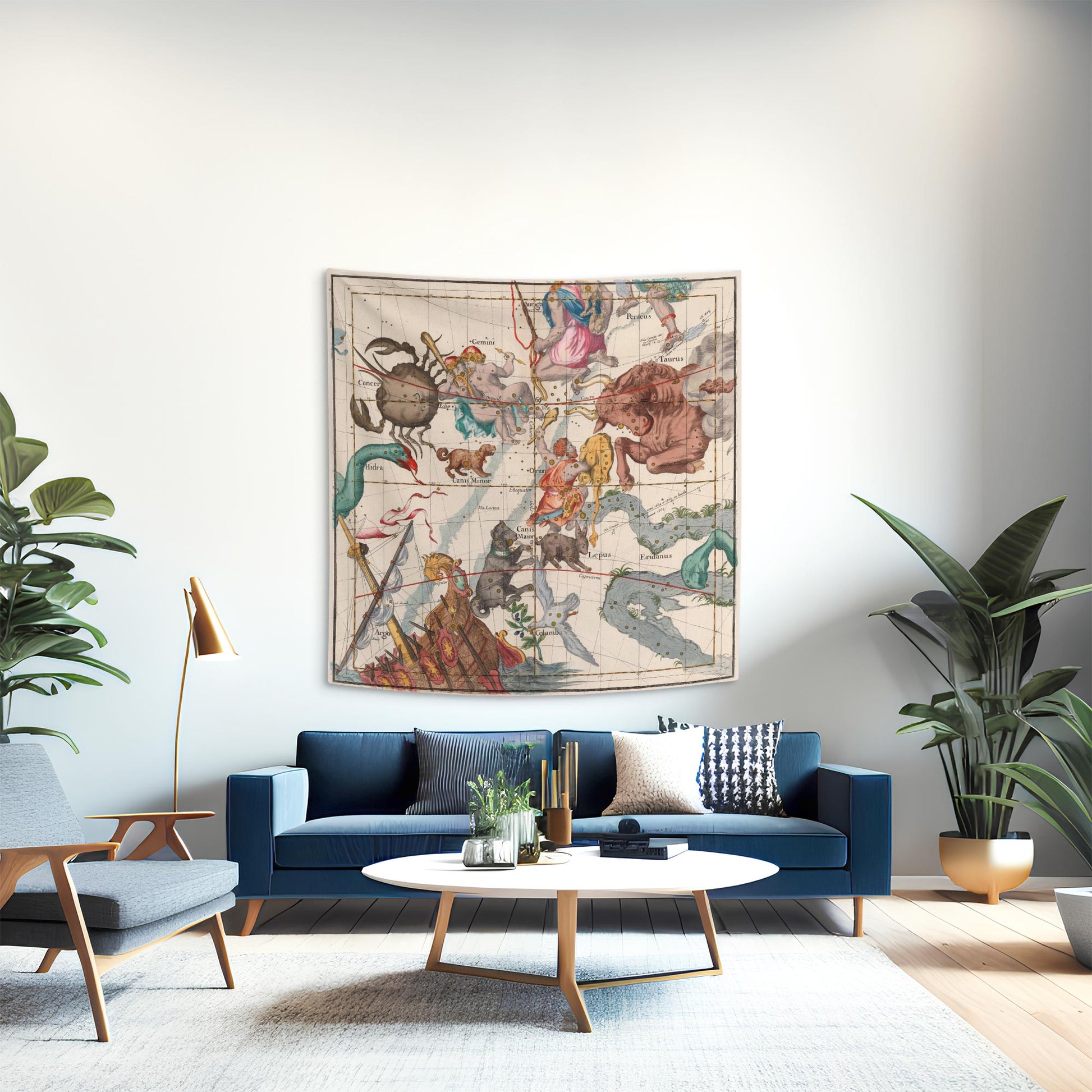 Orion and Taurus constellation tapestry as a statement piece above a blue velvet sofa in a mid-century modern living room.