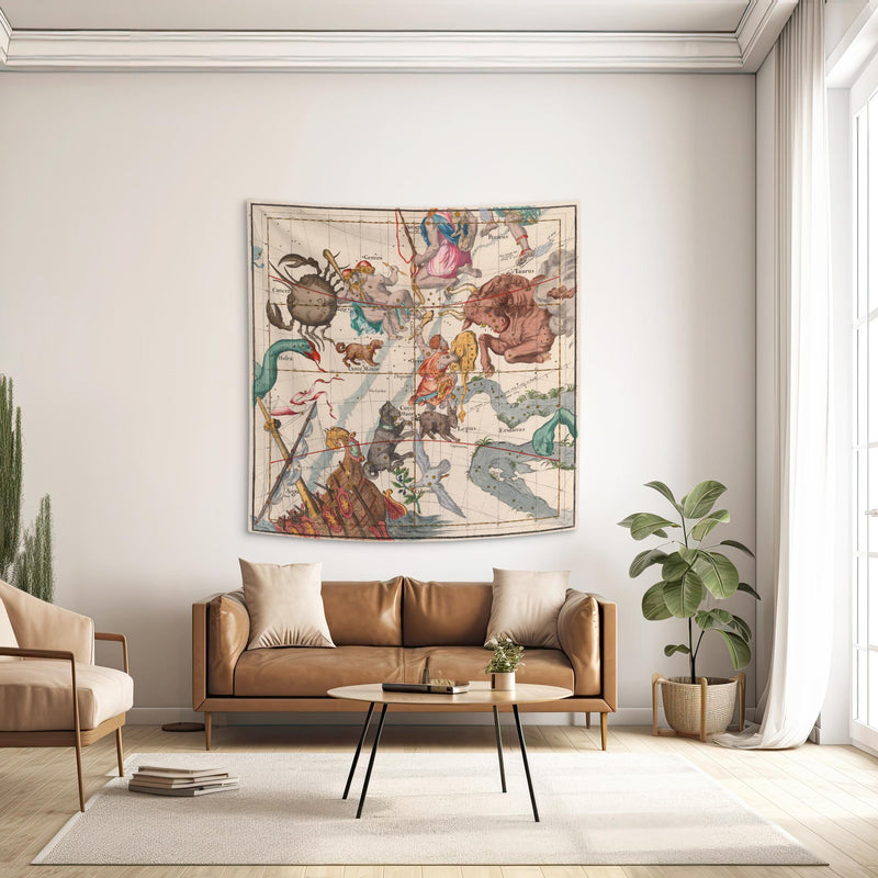Orion and Taurus constellation wall tapestry hanging above a tan leather sofa in a dark academia living room.