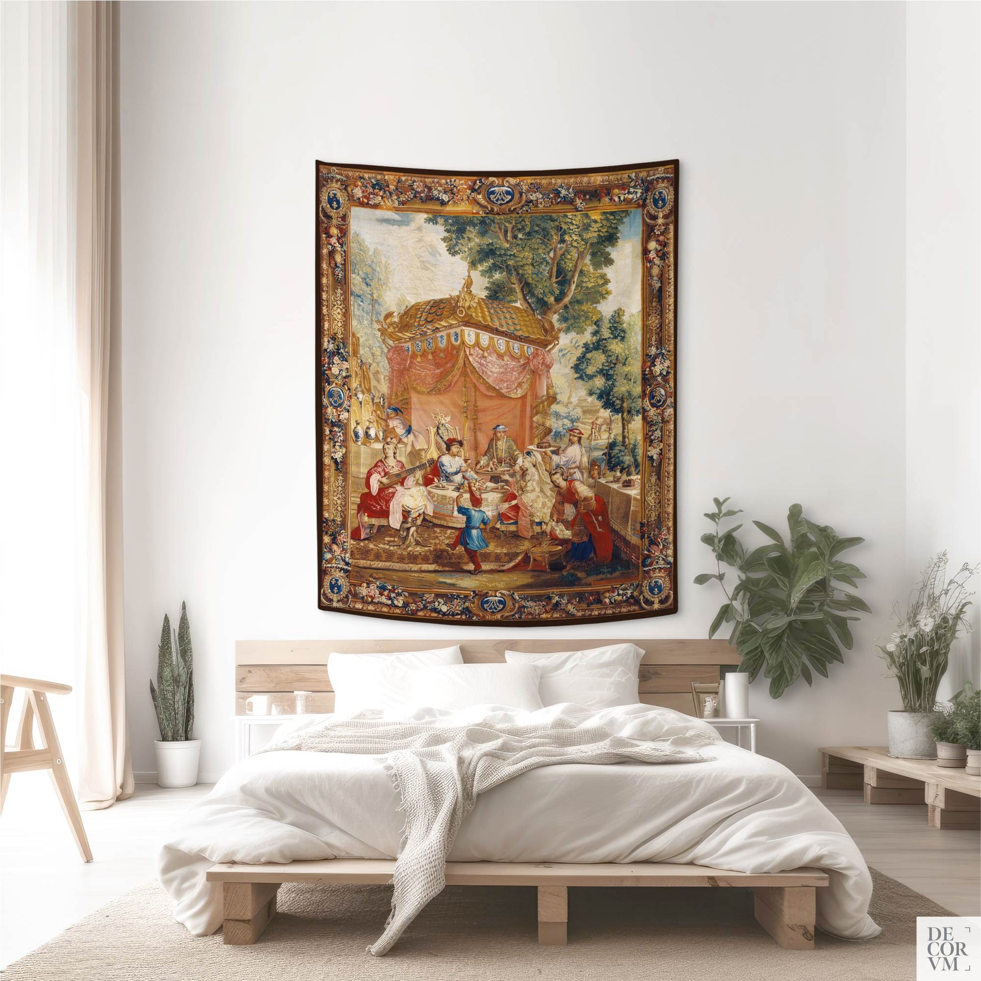 Elegant Chinoiserie fabric art wall tapestry displayed above a low wooden bed in a bright, transitional bedroom styled with potted plants and minimalist decor.