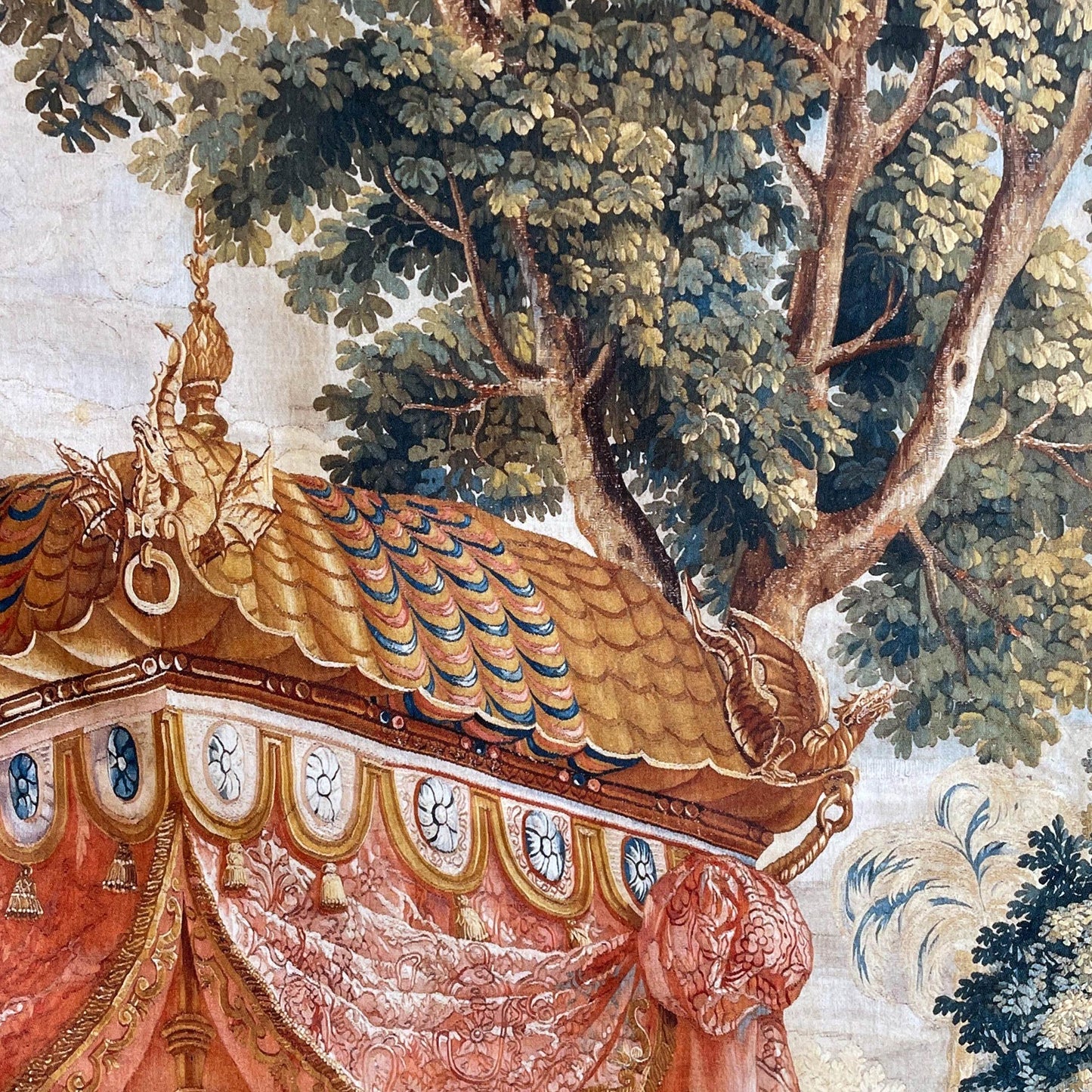 Close-up of the traditional grandmillennial fabric art featuring a majestic Chinoiserie pavilion canopy with golden dragon finials set against a backdrop of lush woven trees.
