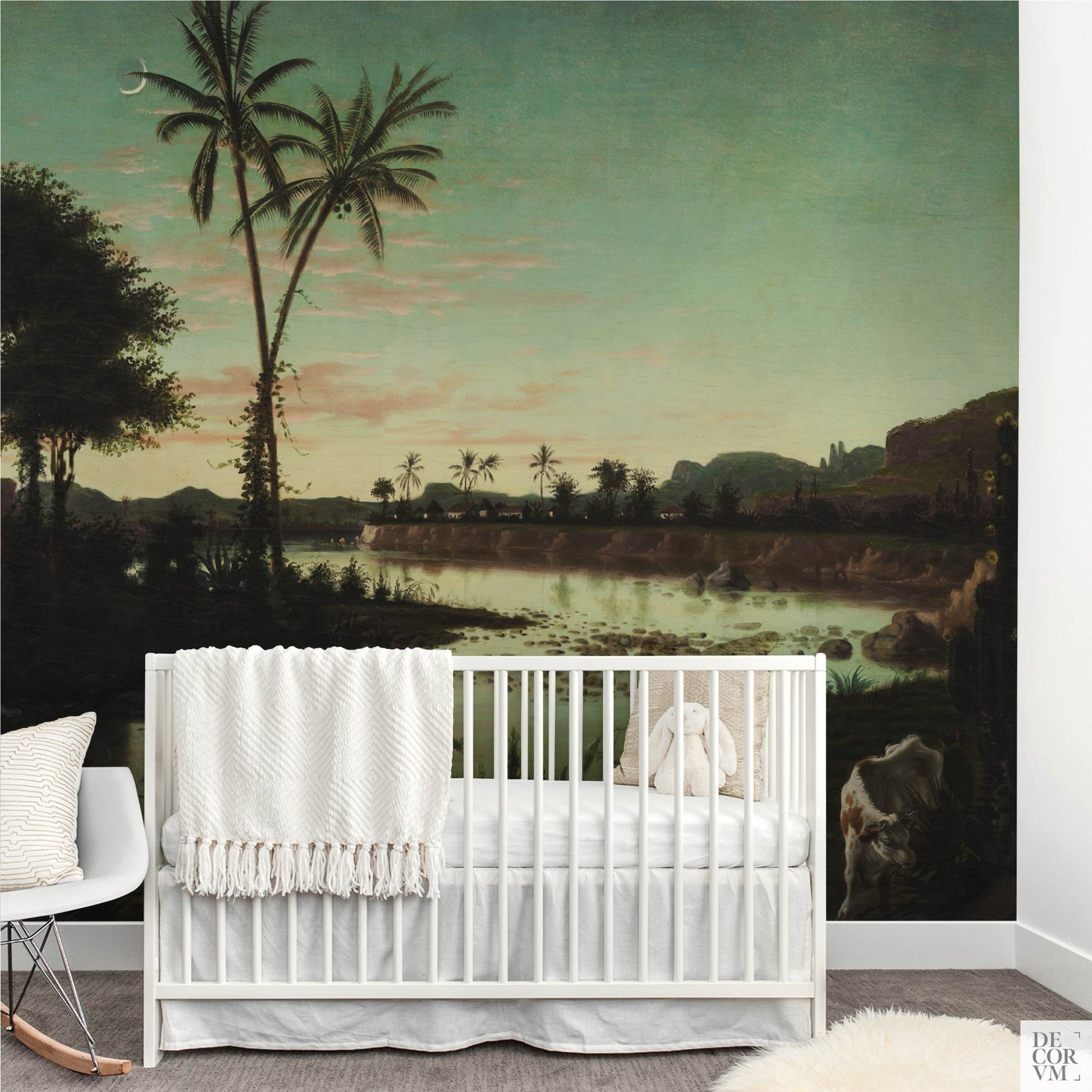 Nursery room setup with a white crib placed directly in front of the Tropical Twilight Palms Wallpaper Mural — Vintage Tropical Decor, with a white rocking chair to the left.