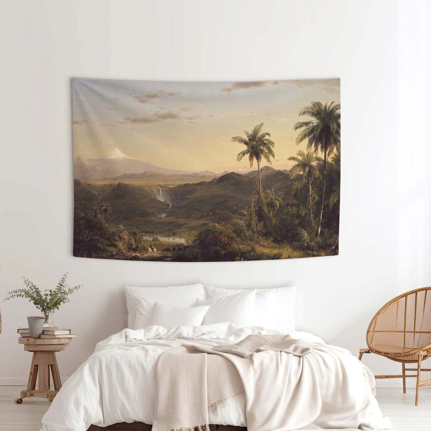 Frederic Church Cotopaxi wall tapestry in a minimalist white bedroom with a rattan chair and linen bedding by Decorvm.