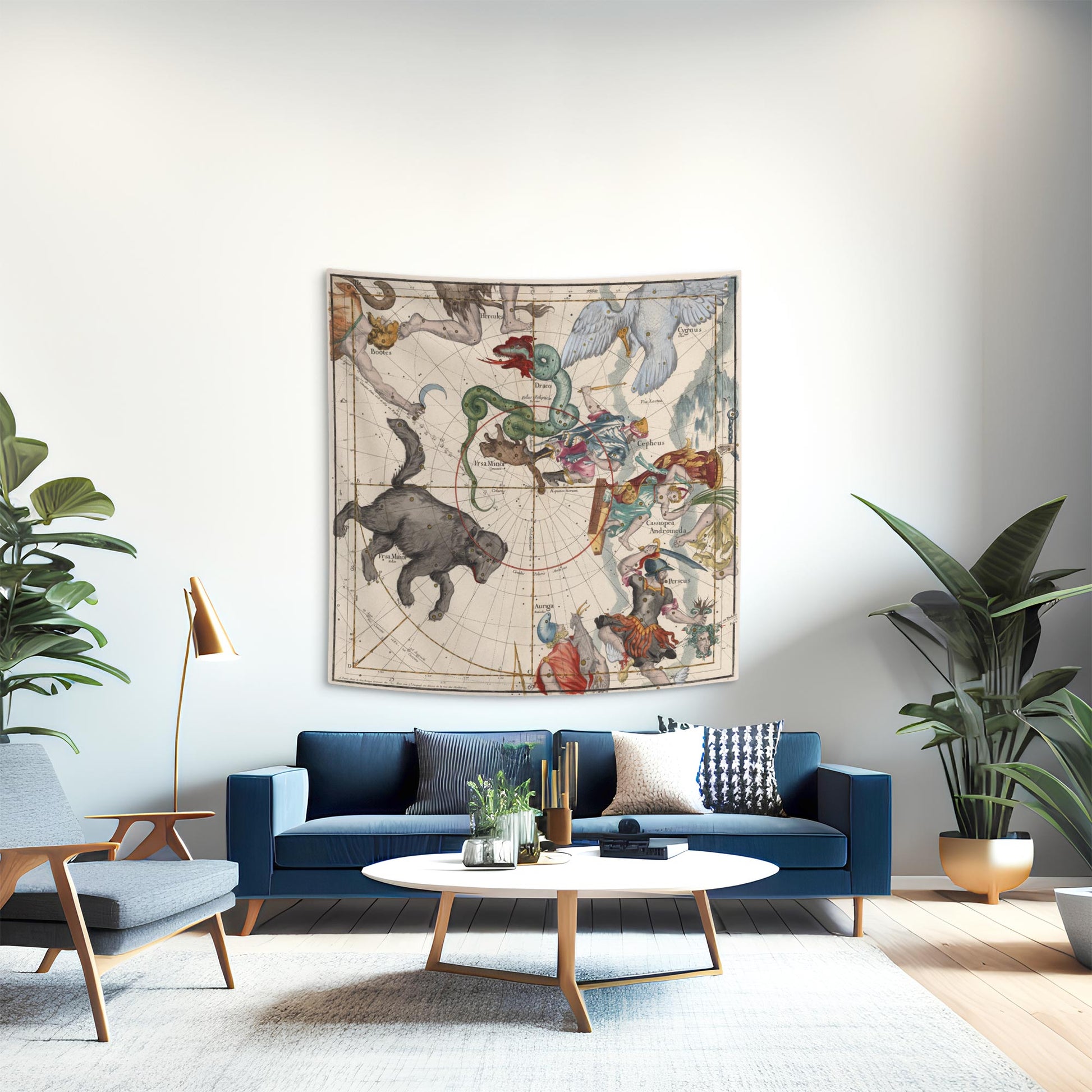 A chic mid-century modern living room styled with a classical northern constellation tapestry hanging as a dramatic statement piece above a sleek blue velvet sofa, surrounded by elegant furnishings.