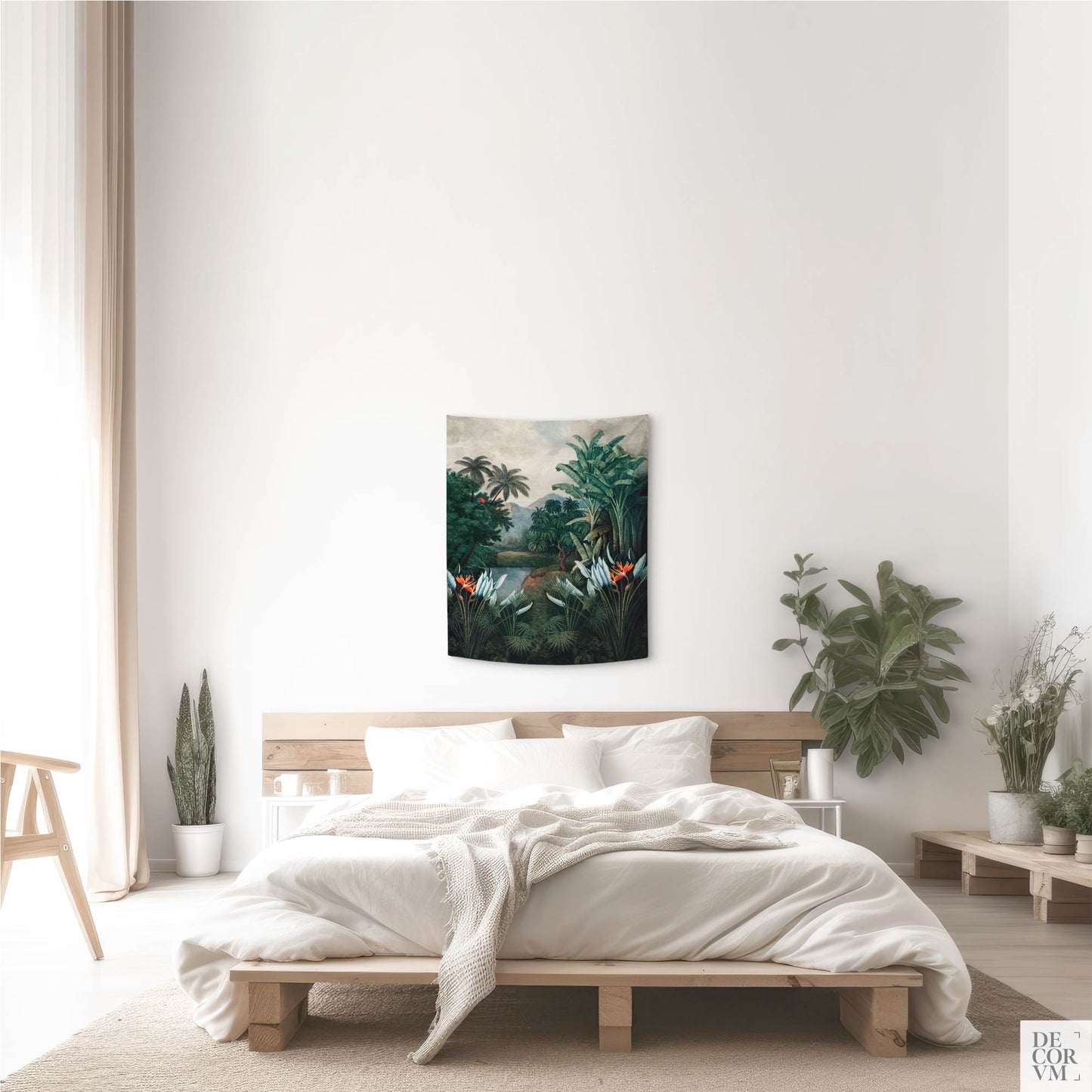 An extra small vintage exotic jungle wall tapestry hung in a minimalist bedroom, highlighting a detailed tropical landscape print with a river and lush foliage.