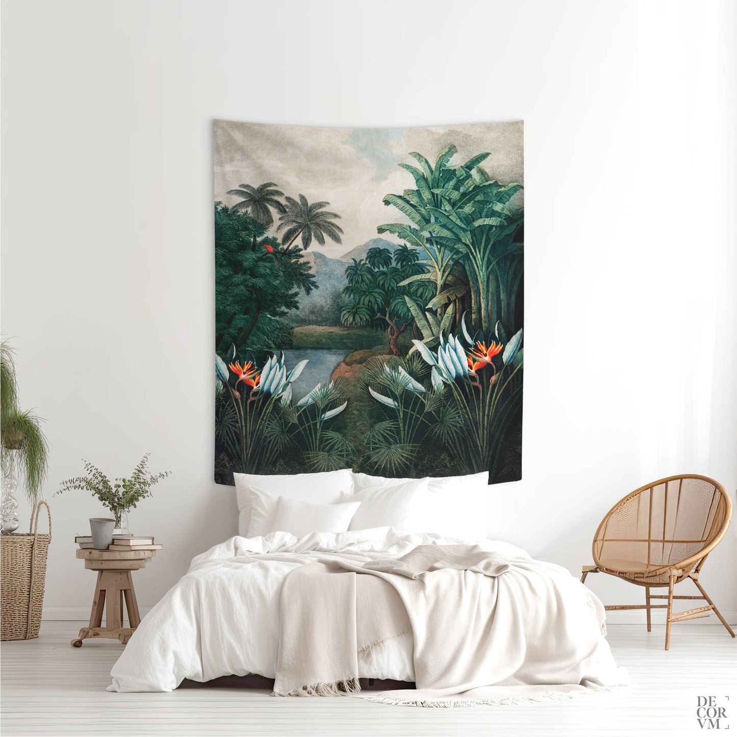 A medium-sized vintage exotic jungle wall tapestry hung above a bed in a bright bedroom, featuring a lush tropical landscape with palm trees and a red parrot.