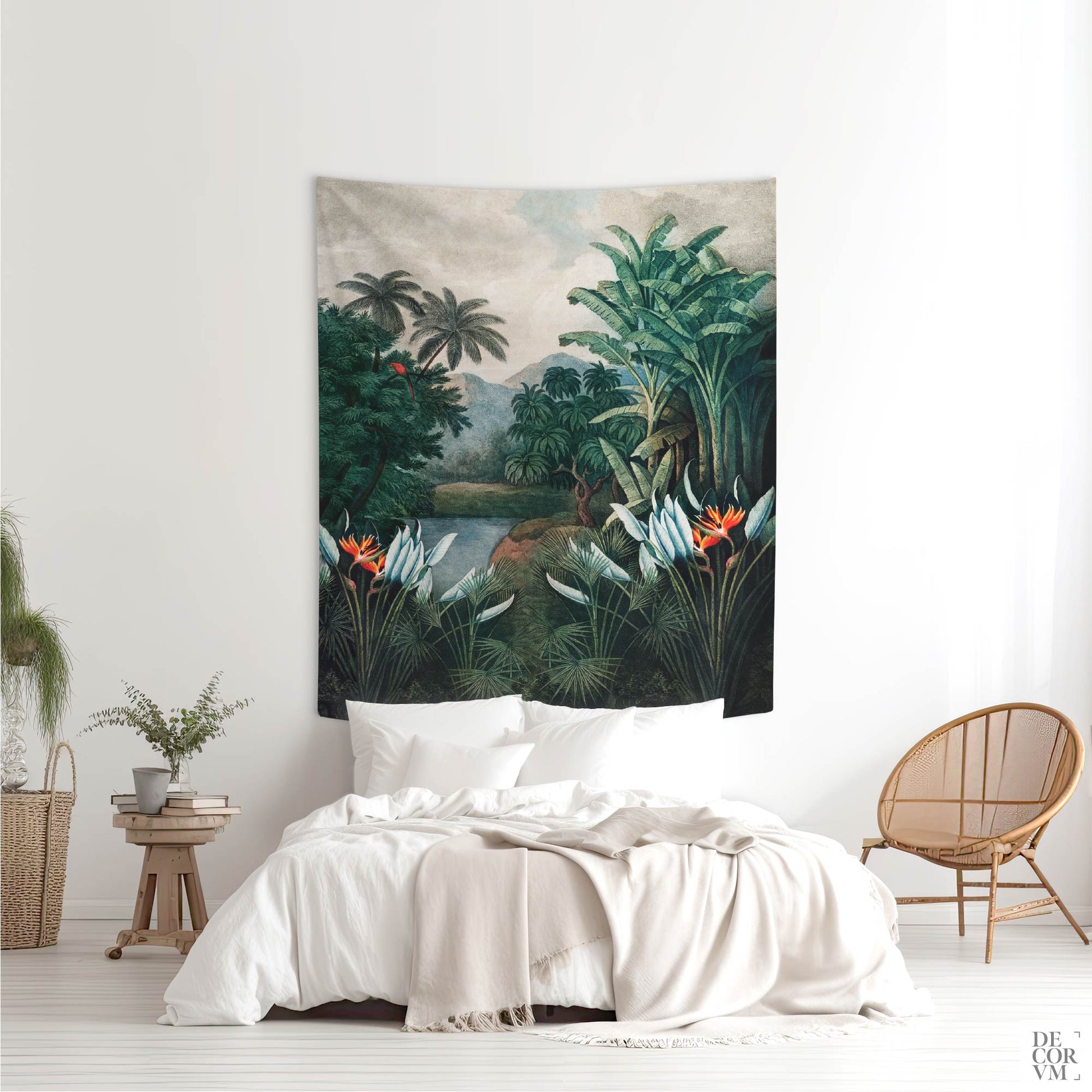 A medium-sized vintage exotic jungle wall tapestry hung above a bed in a bright bedroom, featuring a lush tropical landscape with palm trees and a red parrot.