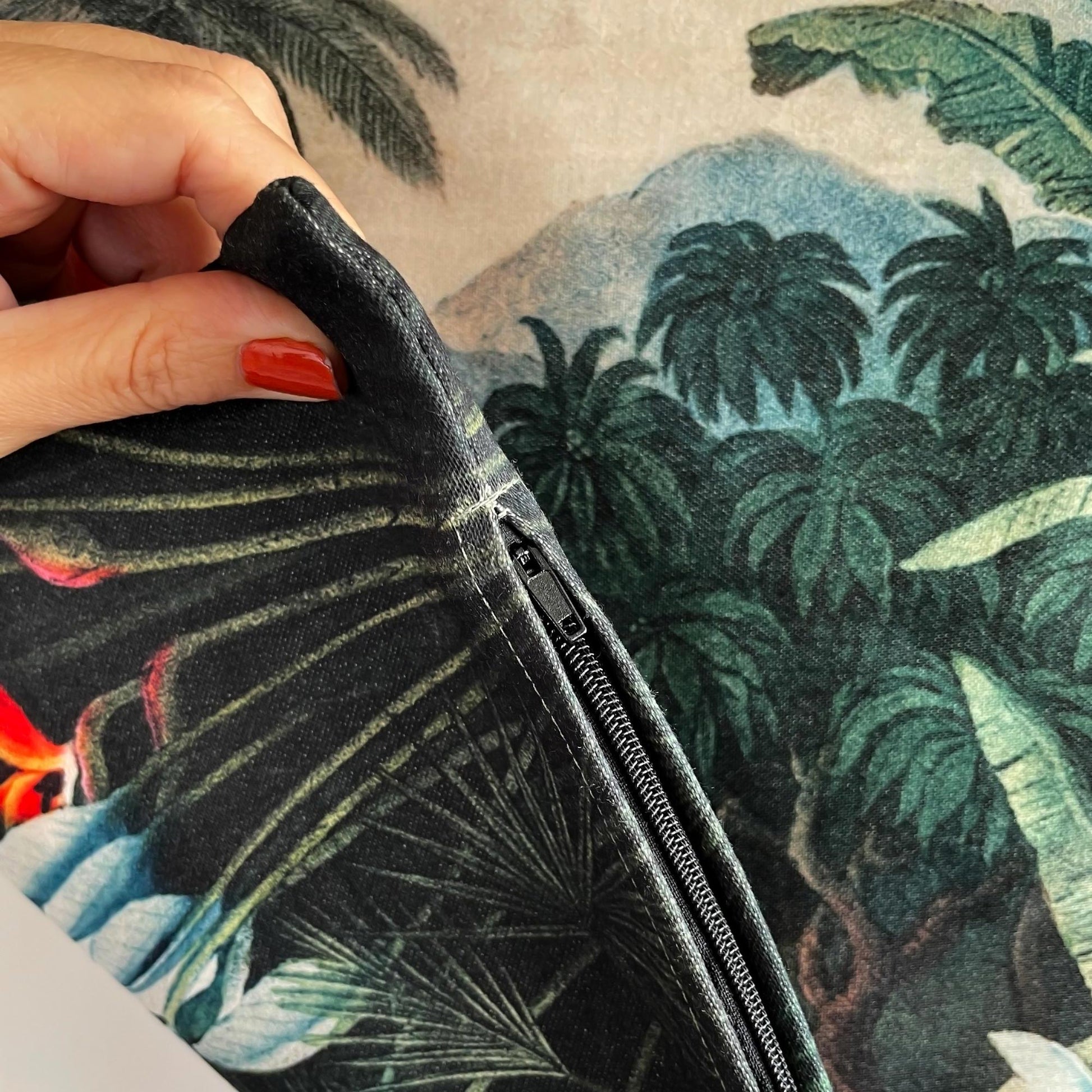Hidden black zipper closure on the vintage tropical jungle throw pillow cover.