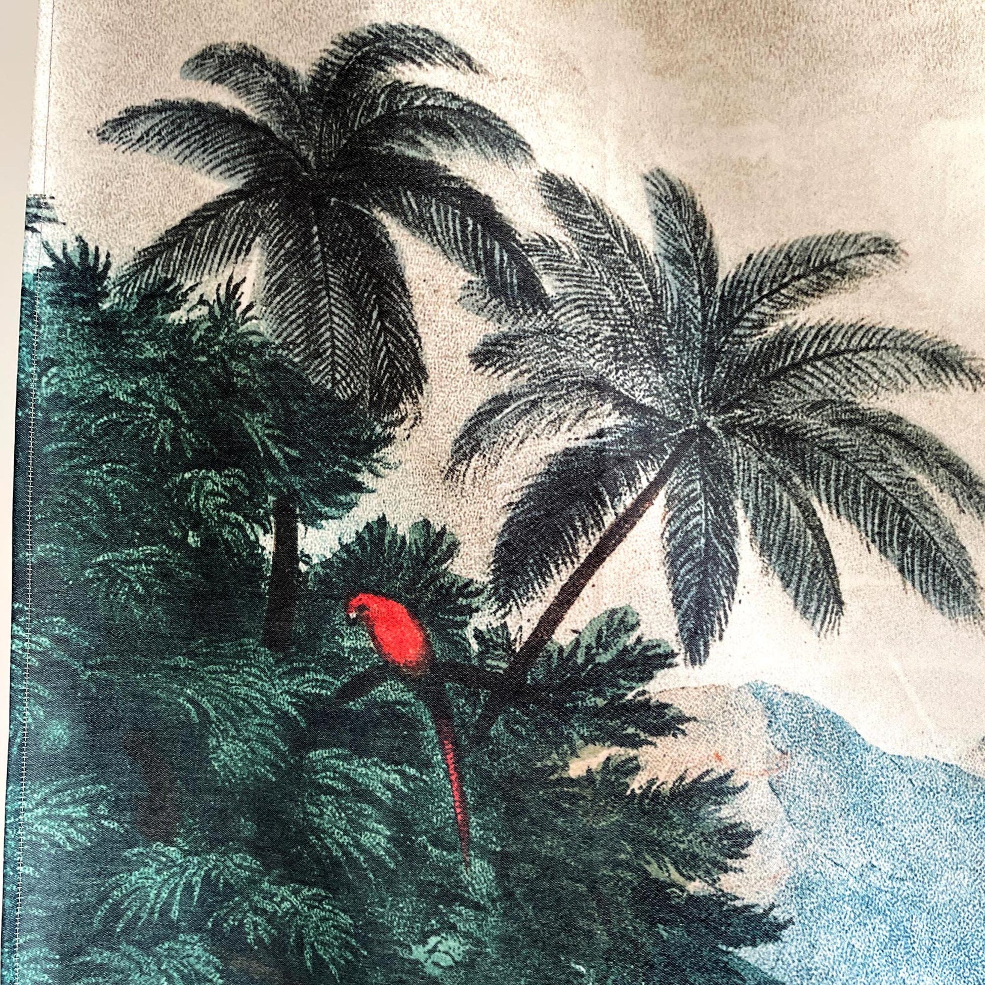 Close-up section of the vintage exotic jungle wall tapestry displaying a bright red parrot perched amidst lush green foliage and palm trees.
