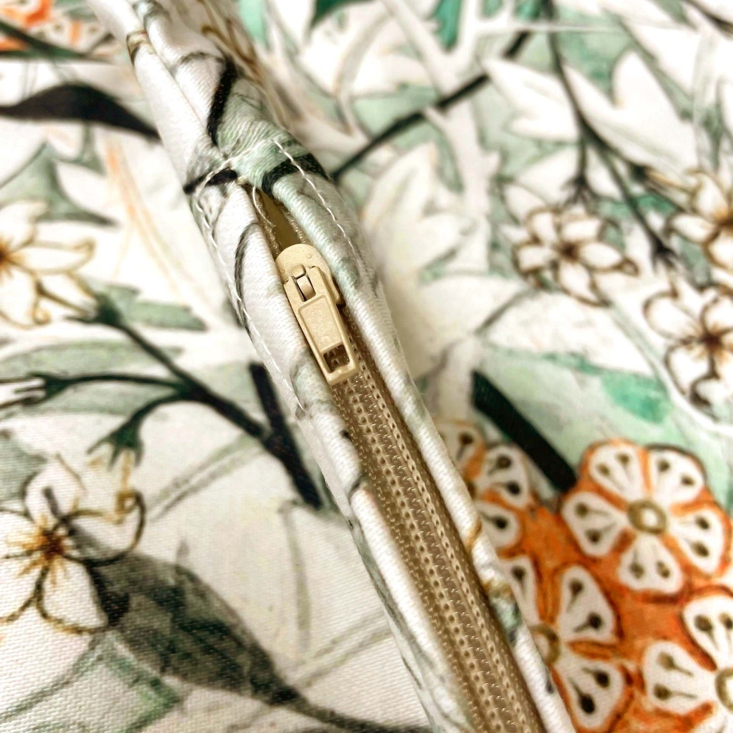 Close-up of the hidden zipper closure on the William Morris Jasmine pillow cover.