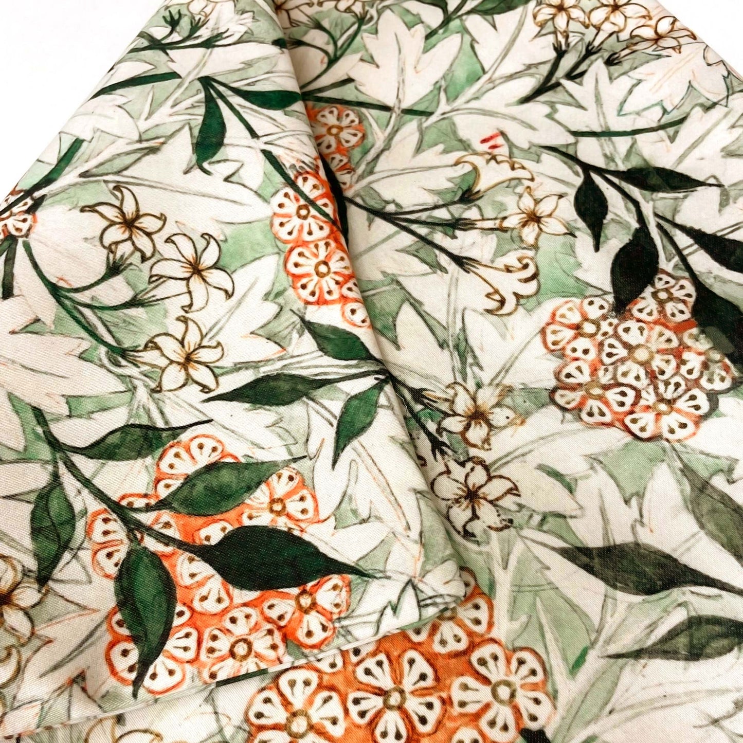 Folded William Morris Jasmine pillow cover showing the fabric drape and printed botanical surface.