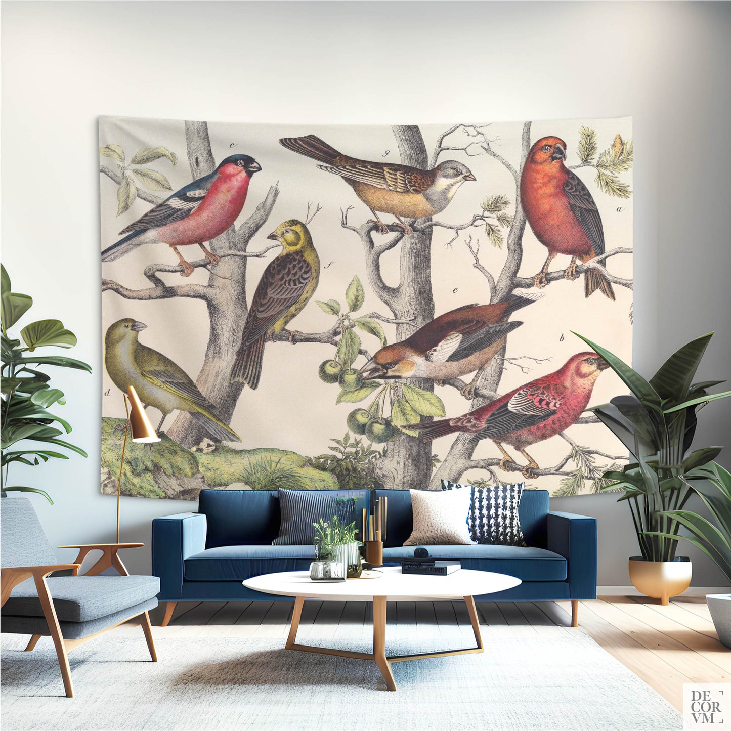 Oversized Vintage Ornithology wall tapestry behind a sleek blue velvet sofa in a stylish mid-century modern living room.
