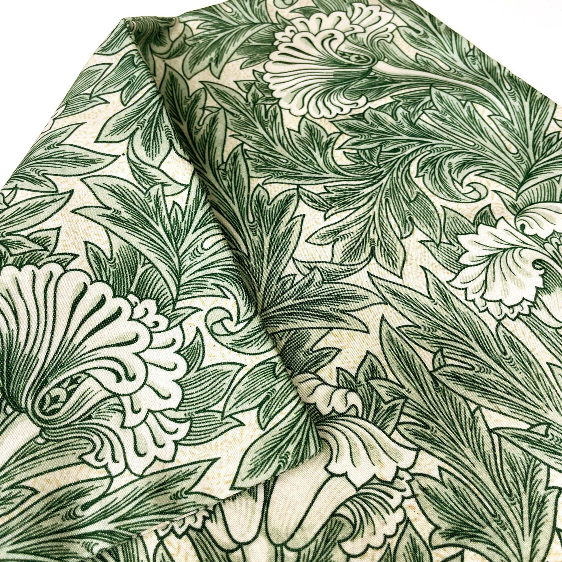Folded William Morris Tulip pillow cover in sage green showing the fabric drape.